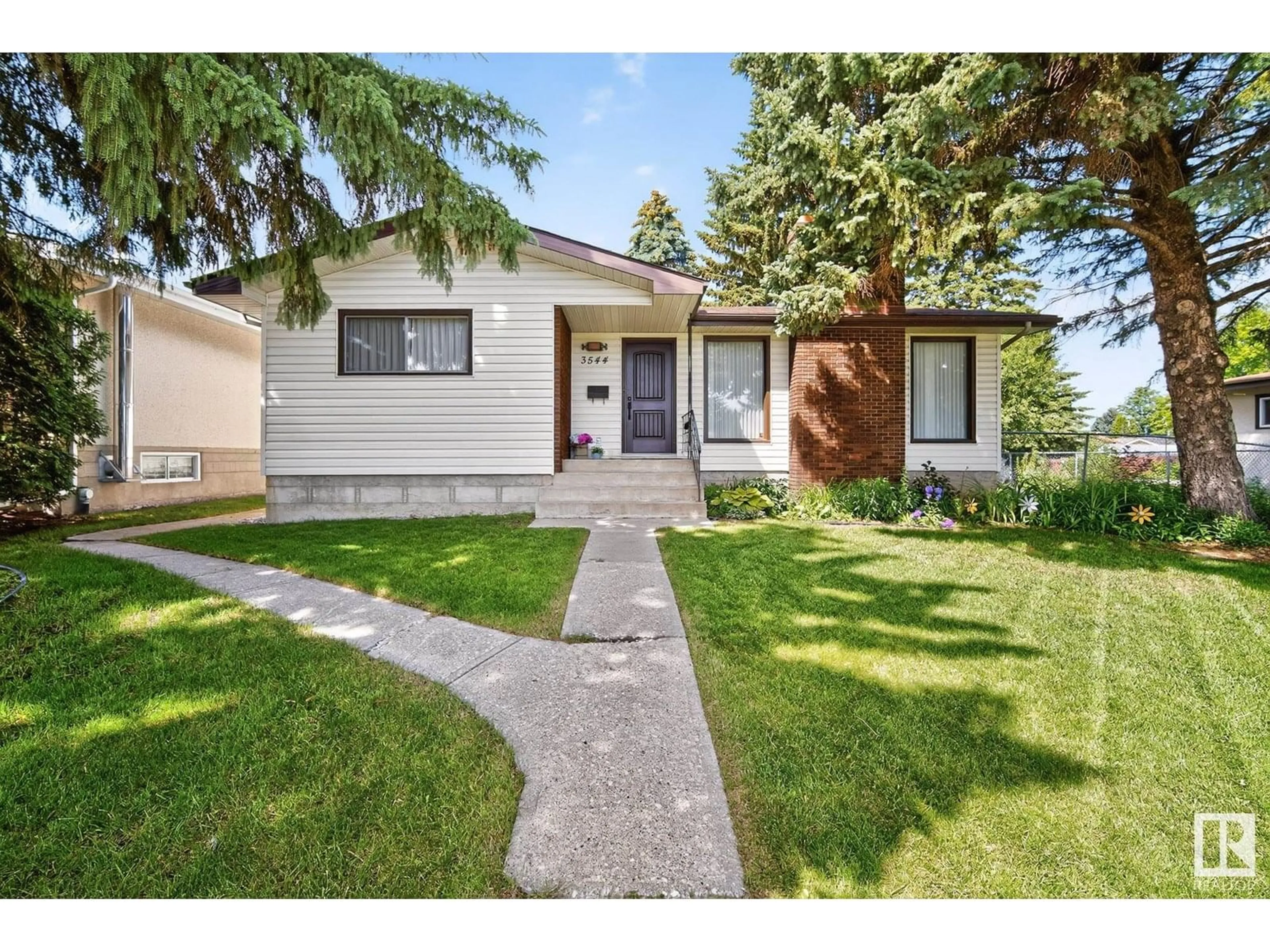 Home with vinyl exterior material, street for 3544 107 ST, Edmonton Alberta T6J1B1