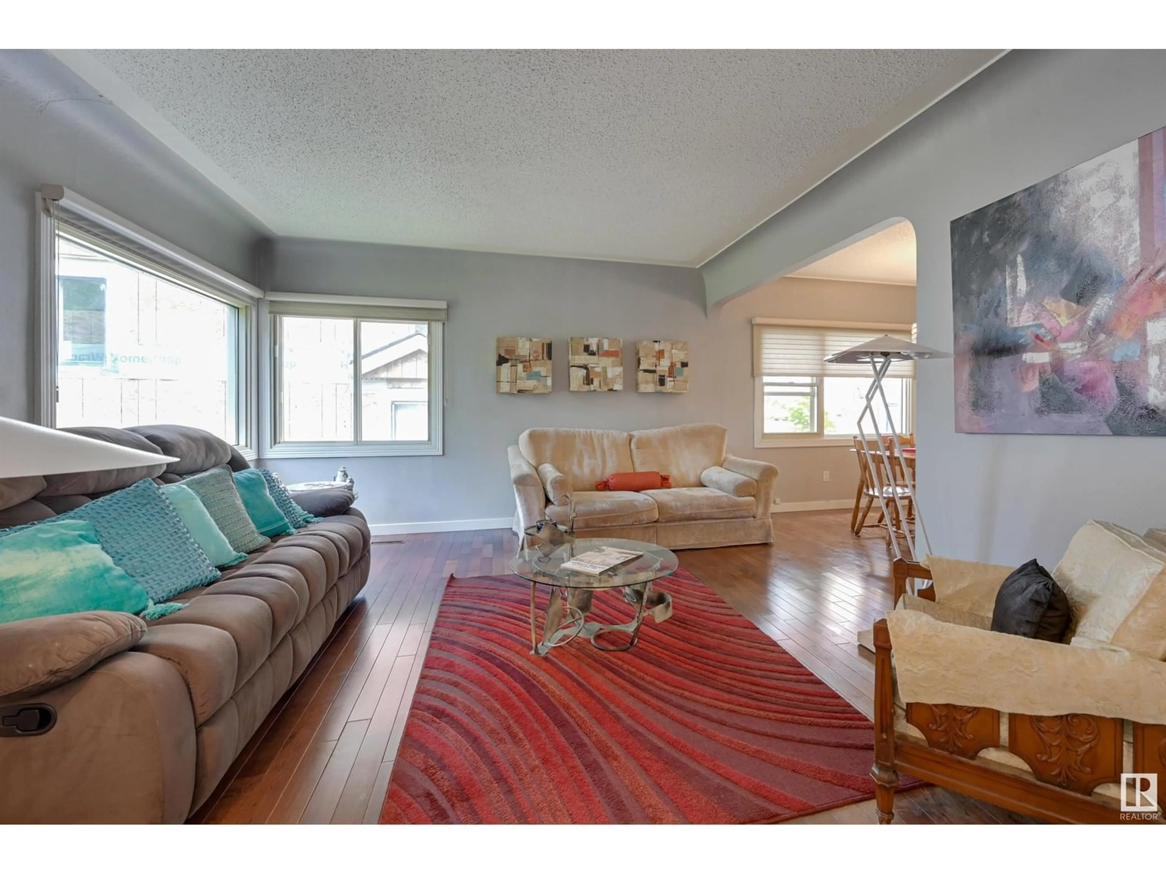 Living room with furniture, wood/laminate floor for 14023 104 AV, Edmonton Alberta T5N0W7
