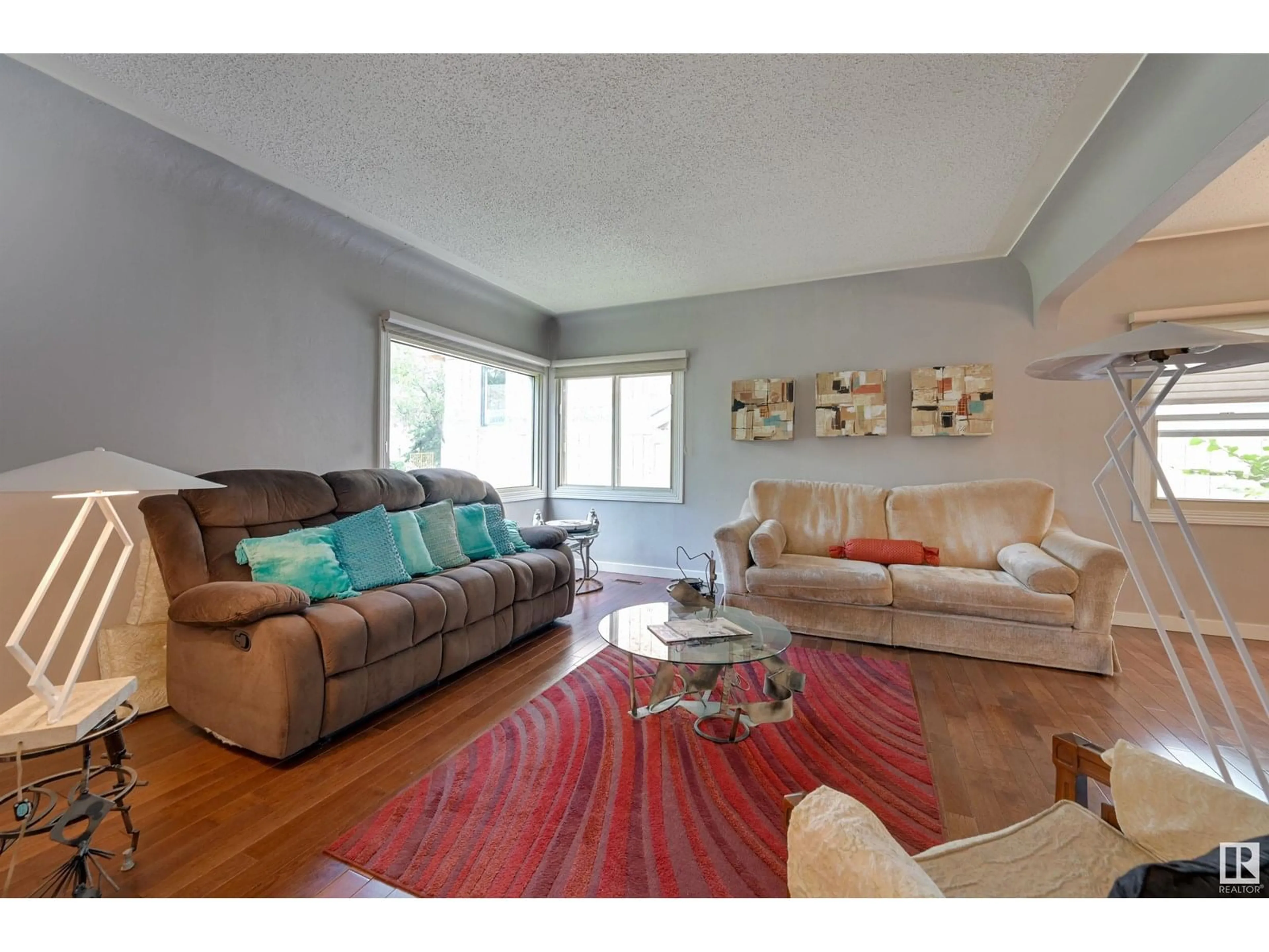 Living room with furniture, wood/laminate floor for 14023 104 AV, Edmonton Alberta T5N0W7