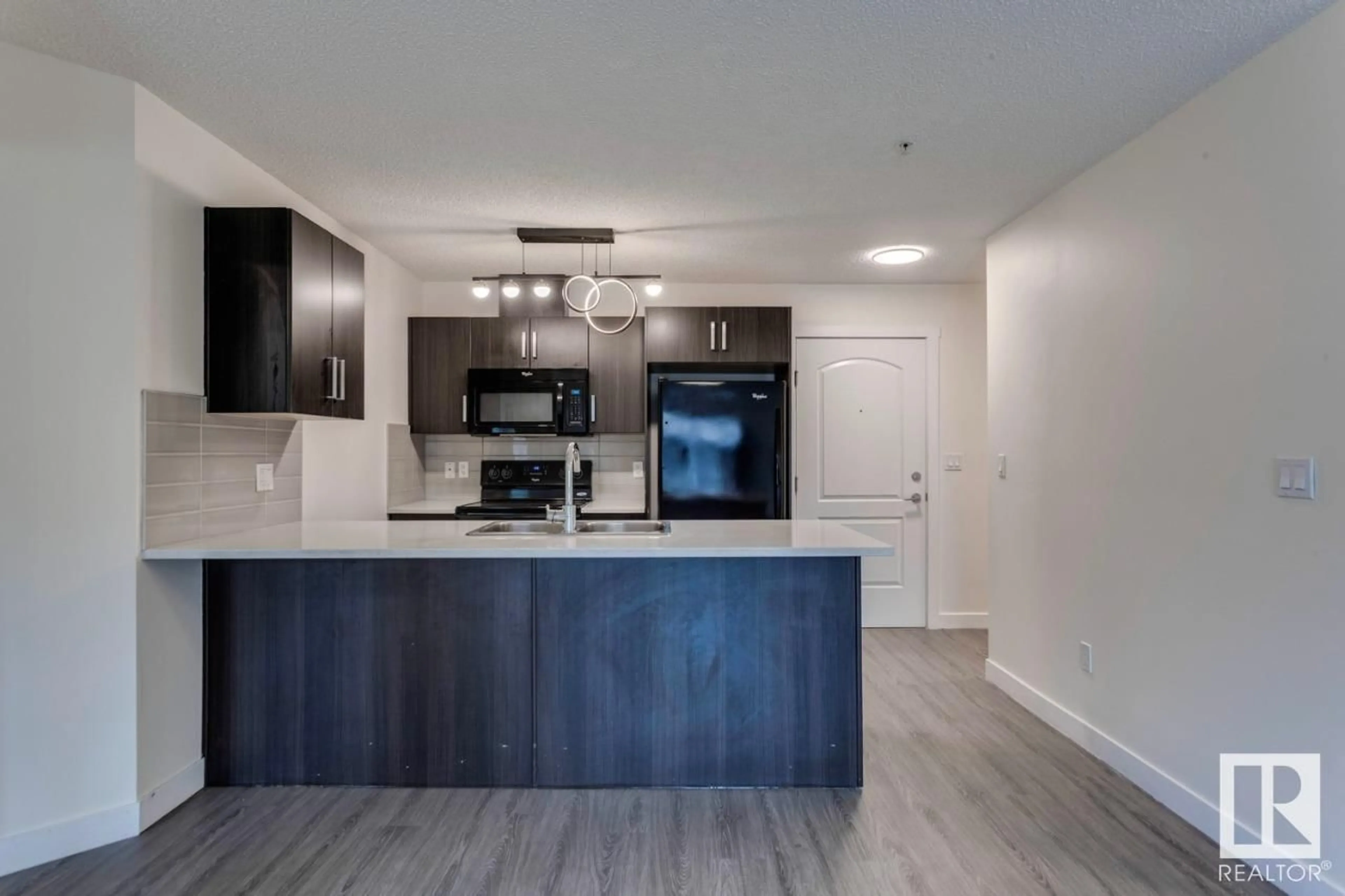 Open concept kitchen, wood/laminate floor for SW - #102 WATT BV, Edmonton Alberta T6X0N4