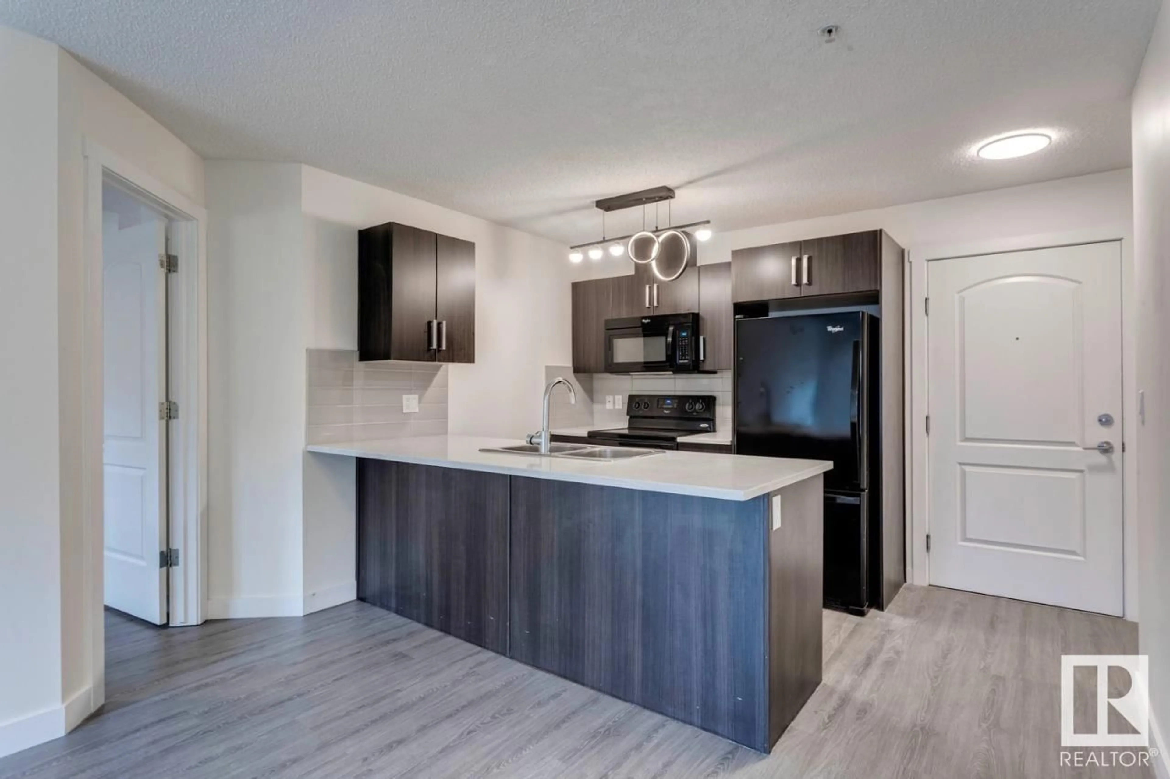 Open concept kitchen, wood/laminate floor for SW - #102 WATT BV, Edmonton Alberta T6X0N4