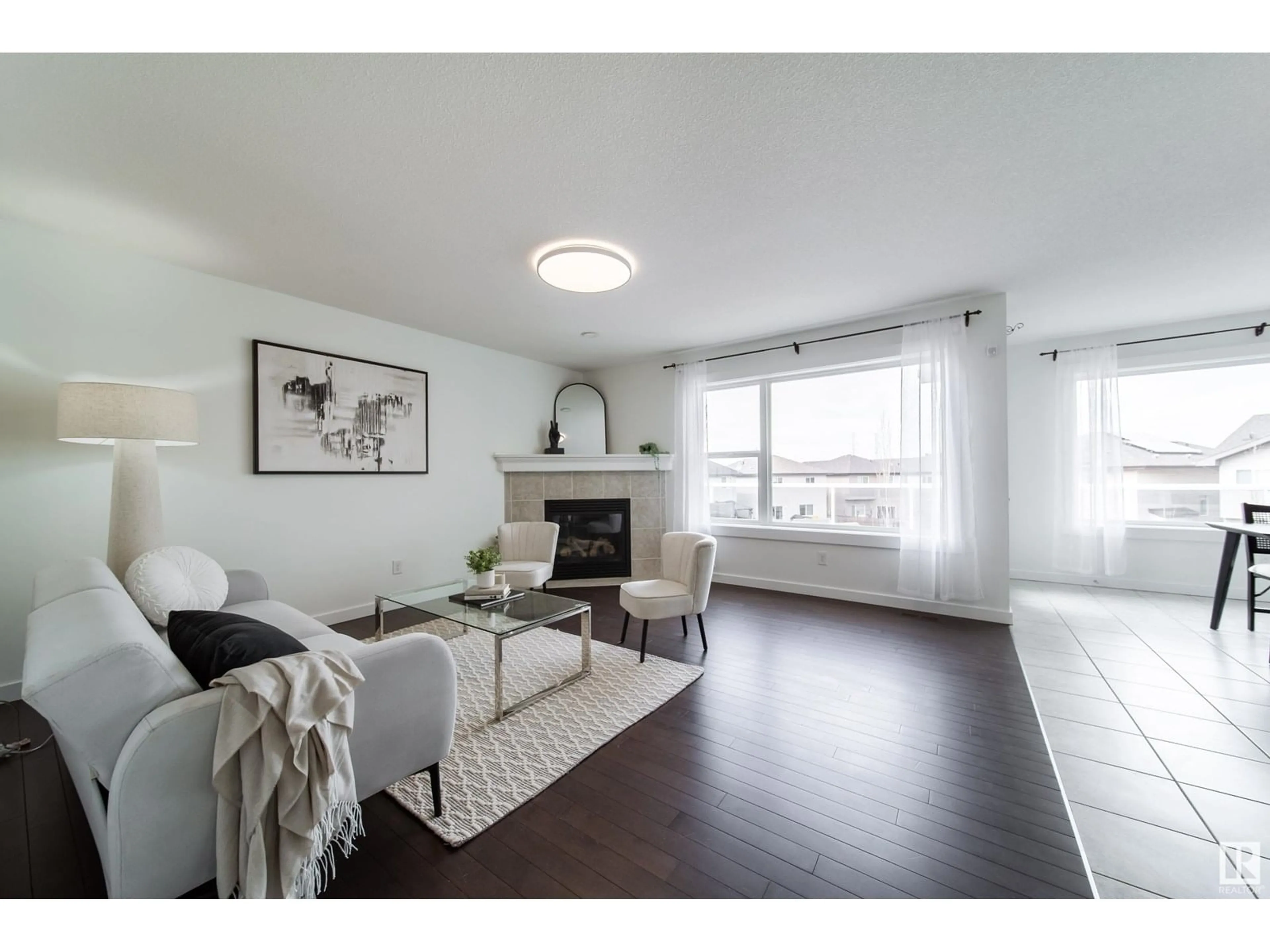 Living room with furniture, wood/laminate floor for 5168 2 AV SW, Edmonton Alberta T6X0R4