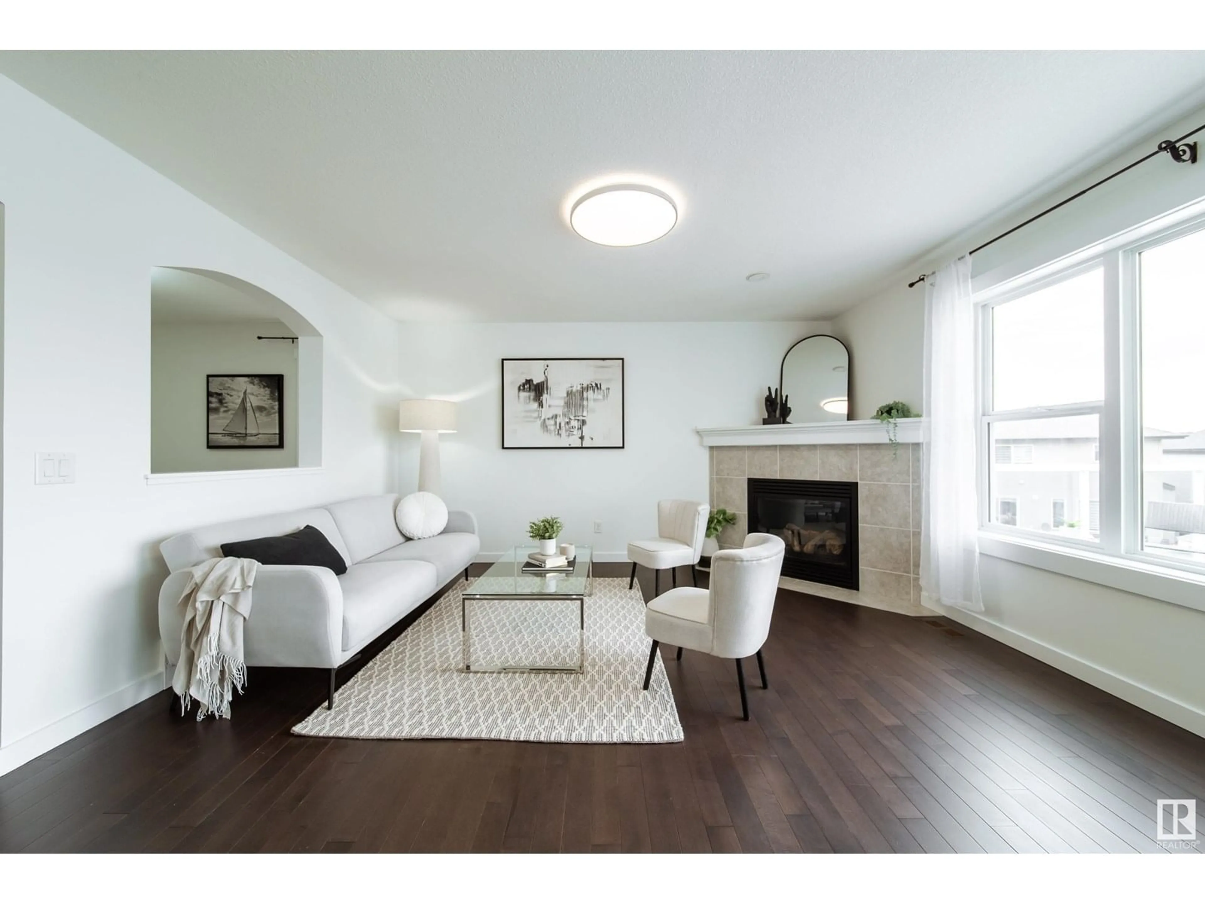 Living room with furniture, wood/laminate floor for 5168 2 AV SW, Edmonton Alberta T6X0R4