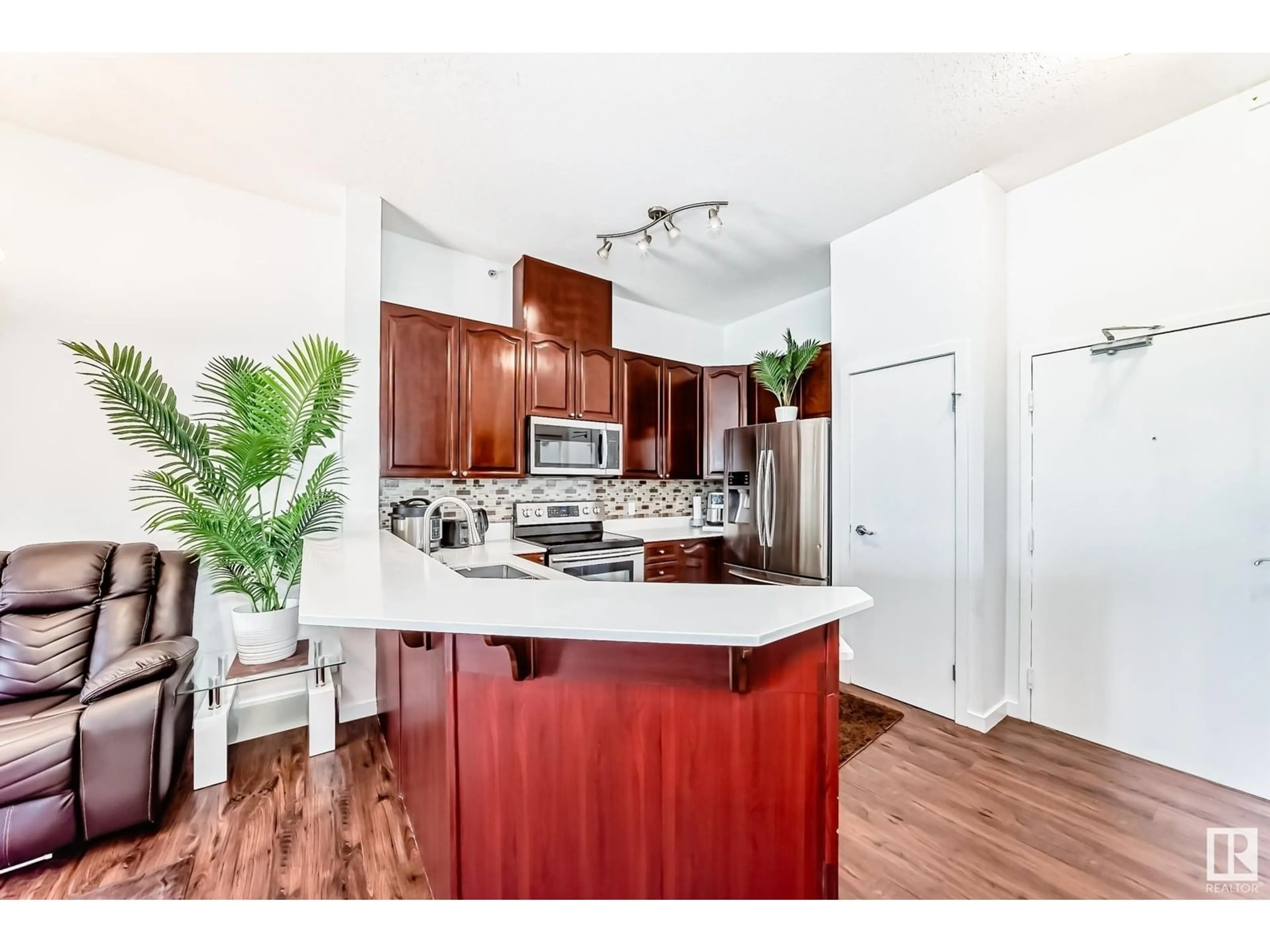 Open concept kitchen, wood/laminate floor for #412 - 4312 139 AV, Edmonton Alberta T5Y3J4
