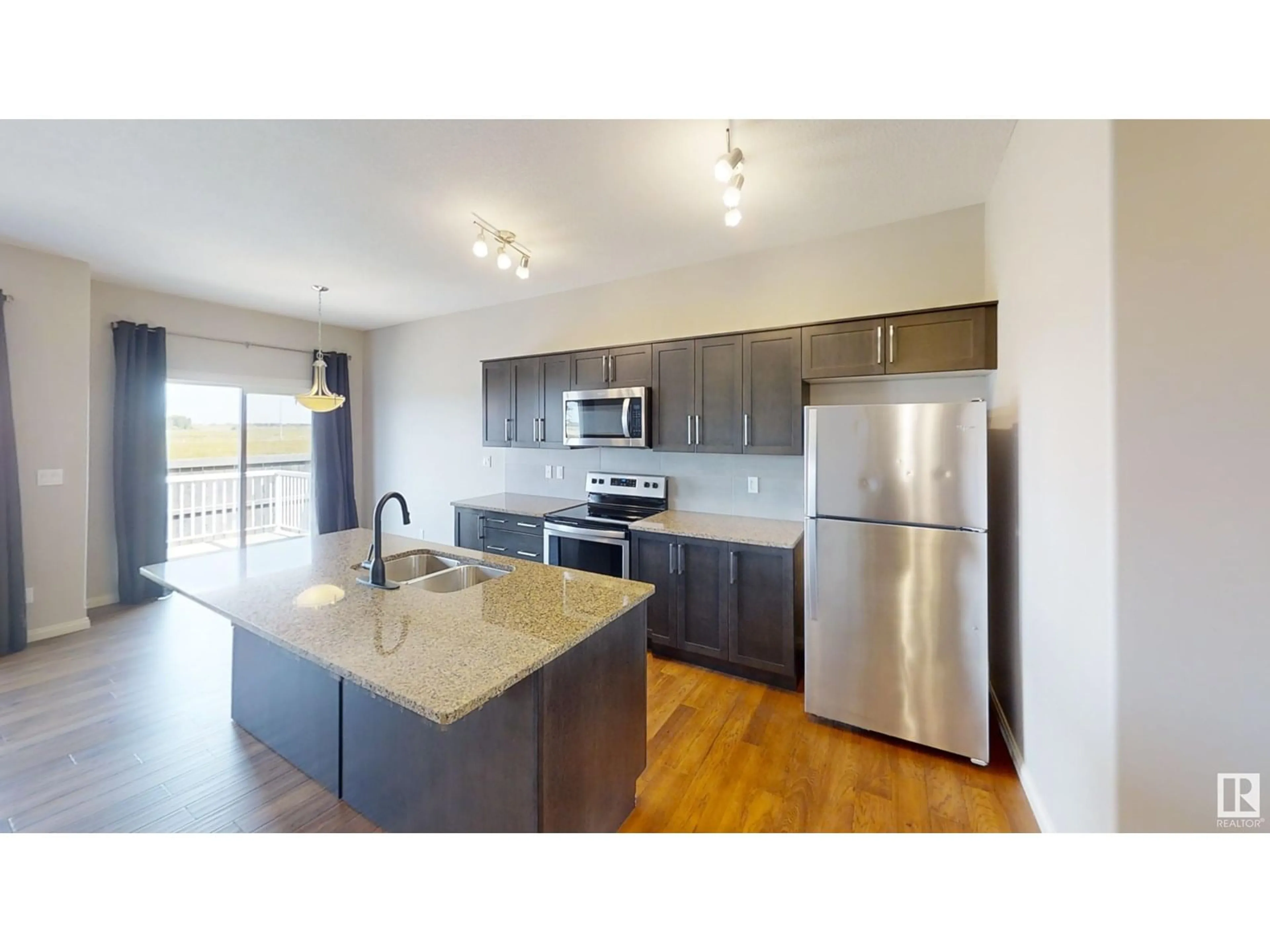 Open concept kitchen, wood/laminate floor for #34 - 18230 104A ST NW, Edmonton Alberta T5X0G9
