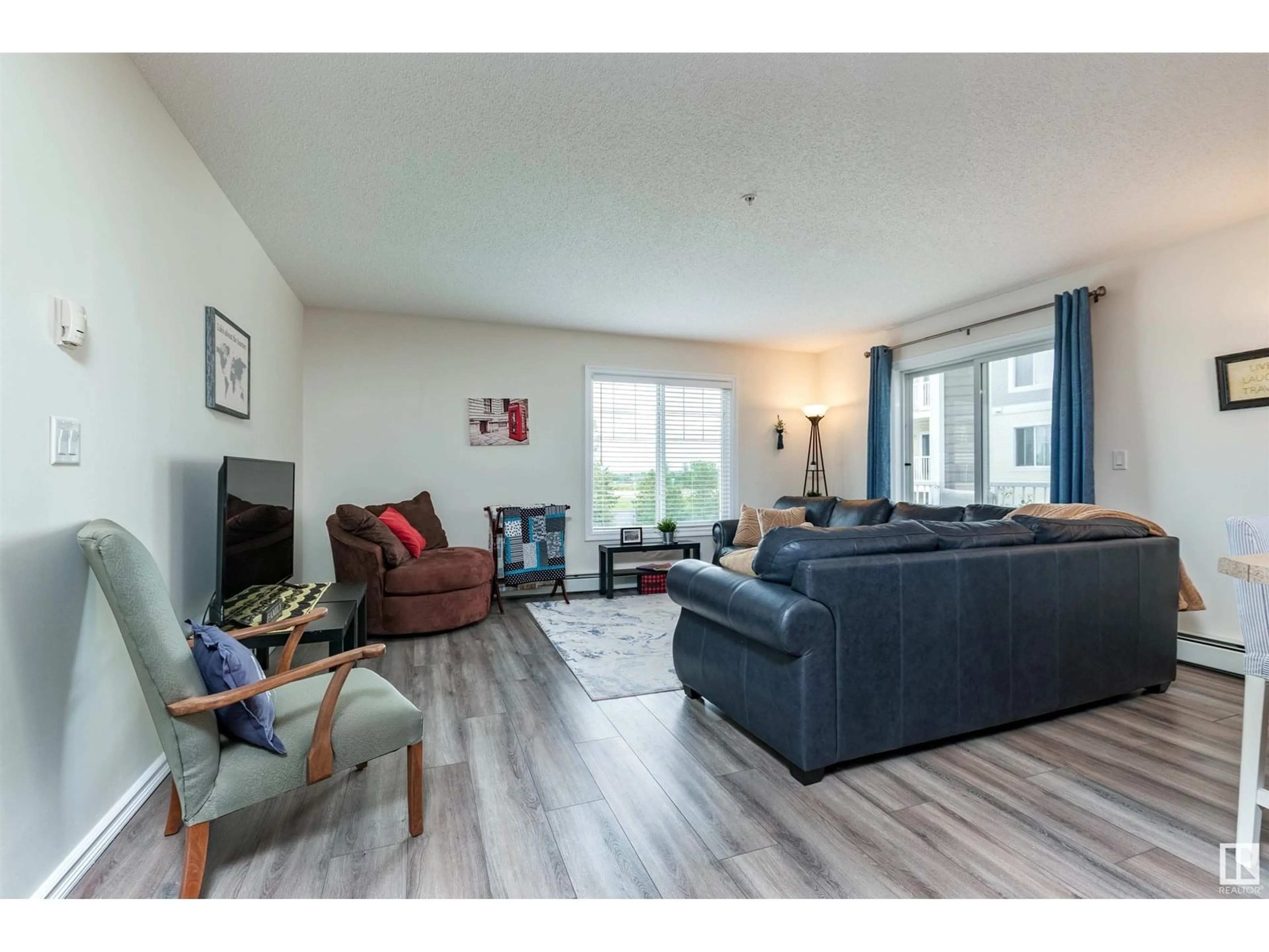 Living room with furniture, wood/laminate floor for 315 - 4403 23 ST NW, Edmonton Alberta T6T0E4