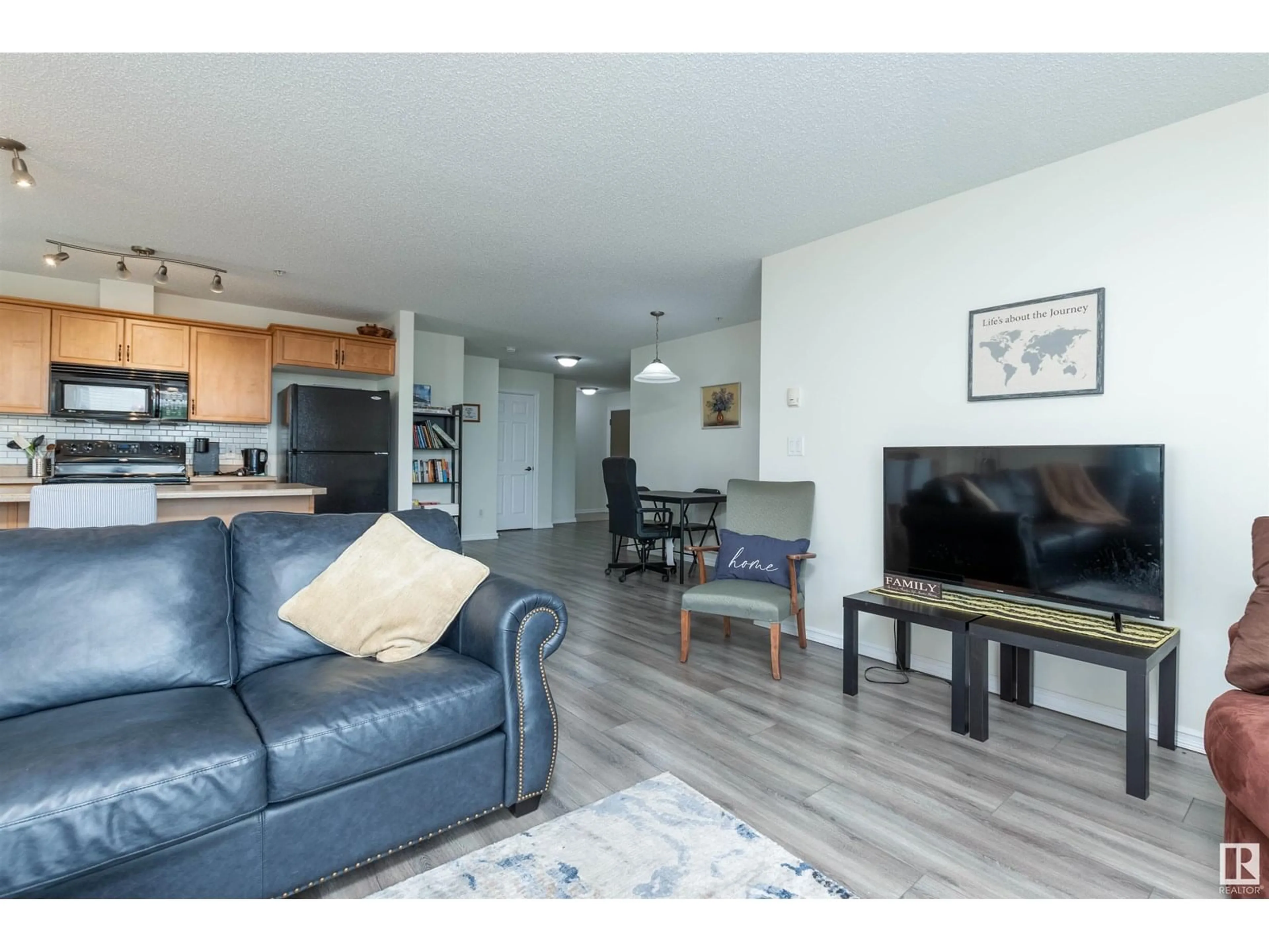 Living room with furniture, wood/laminate floor for 315 - 4403 23 ST NW, Edmonton Alberta T6T0E4