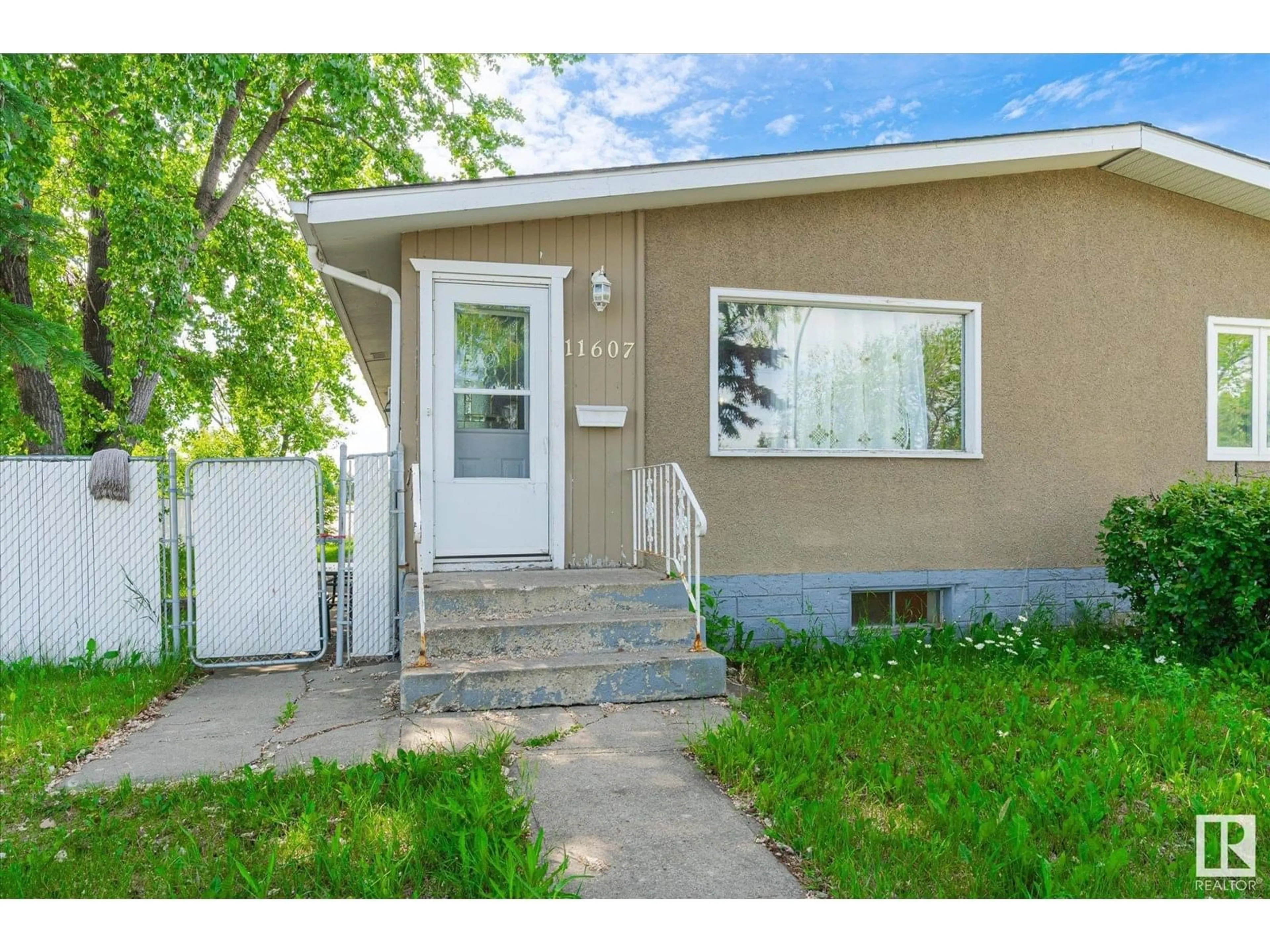 Home with vinyl exterior material, street for 11607 137 AV, Edmonton Alberta T5E1Z6