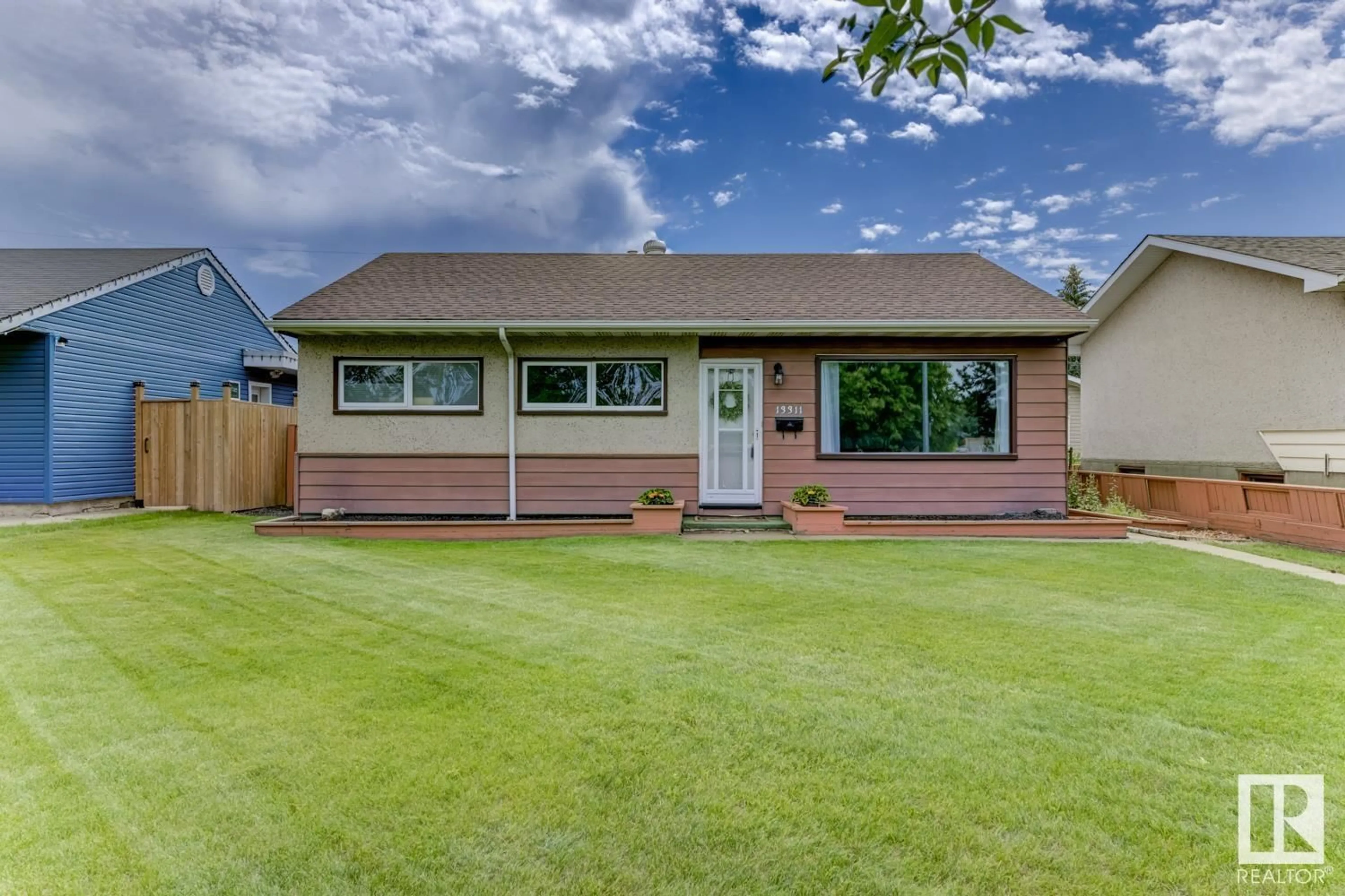 Home with vinyl exterior material, street for 13311 132 AV NW, Edmonton Alberta T5L3R4