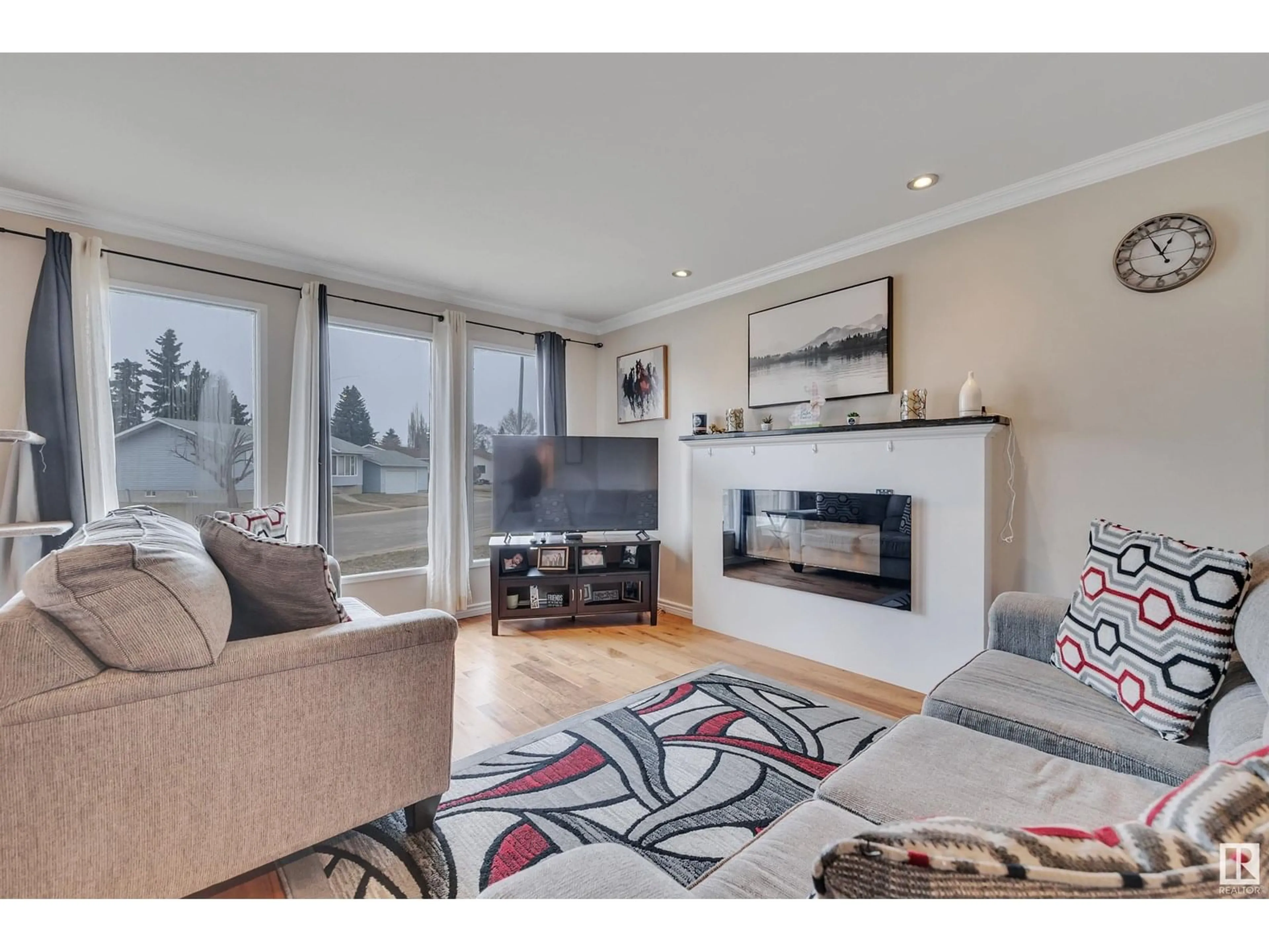 Living room with furniture, wood/laminate floor for 6428 15 AV, Edmonton Alberta T6L1S6