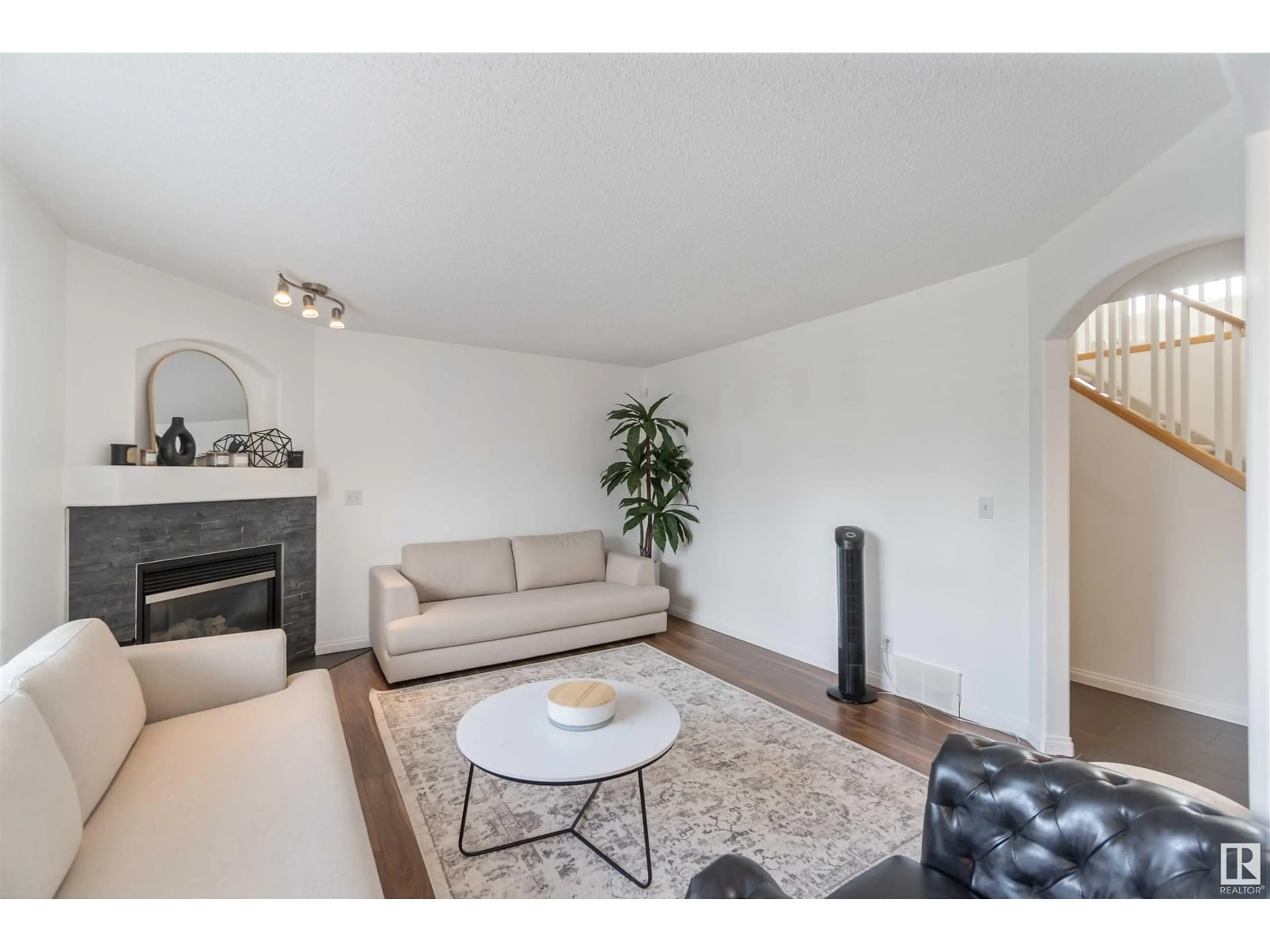 Living room with furniture, wood/laminate floor for NW - 8320 172 AV, Edmonton Alberta T5Z3M1