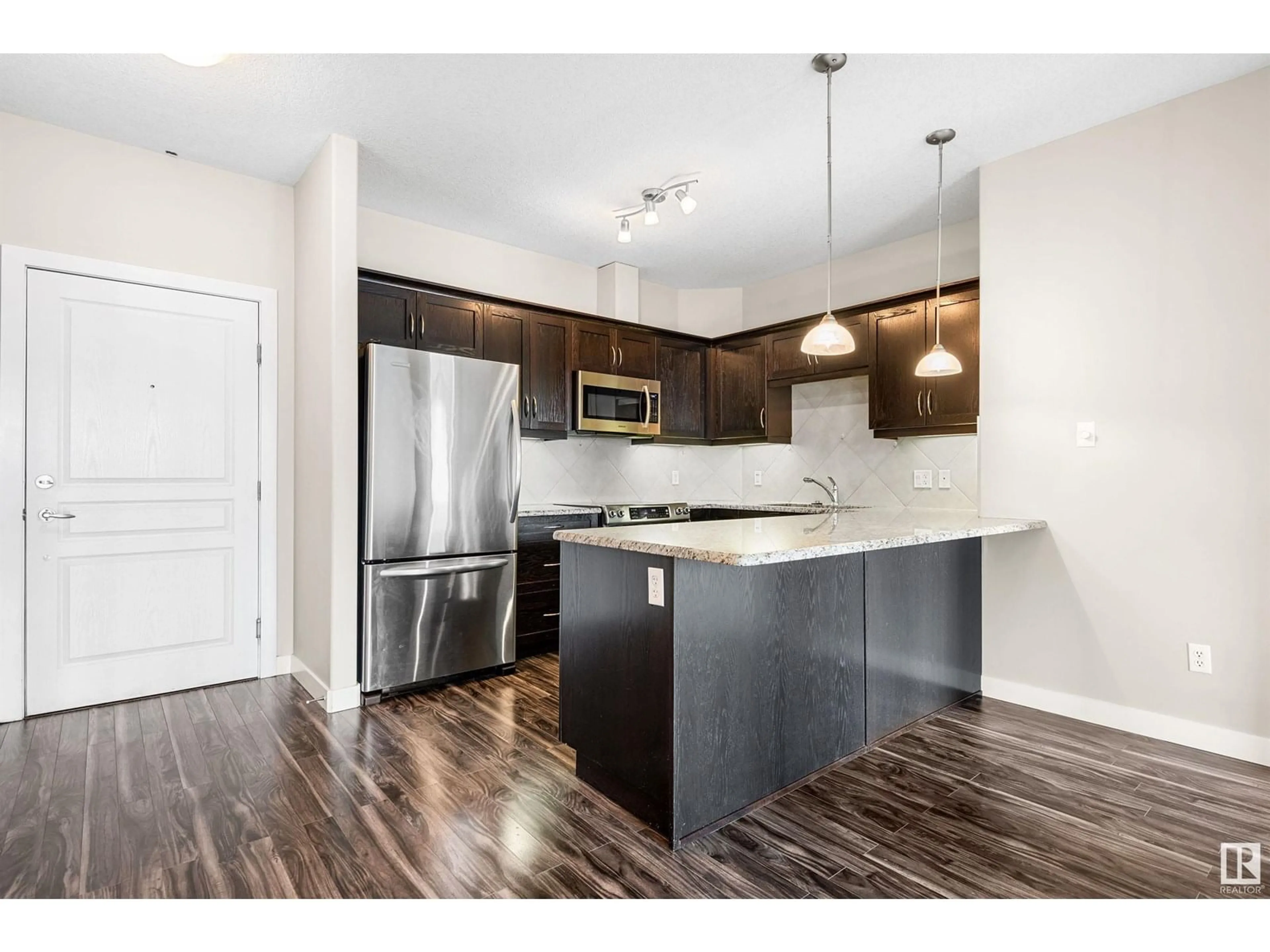 Open concept kitchen, wood/laminate floor for 3204 - 7347 SOUTH TERWILLEGAR DR, Edmonton Alberta T6R0M3