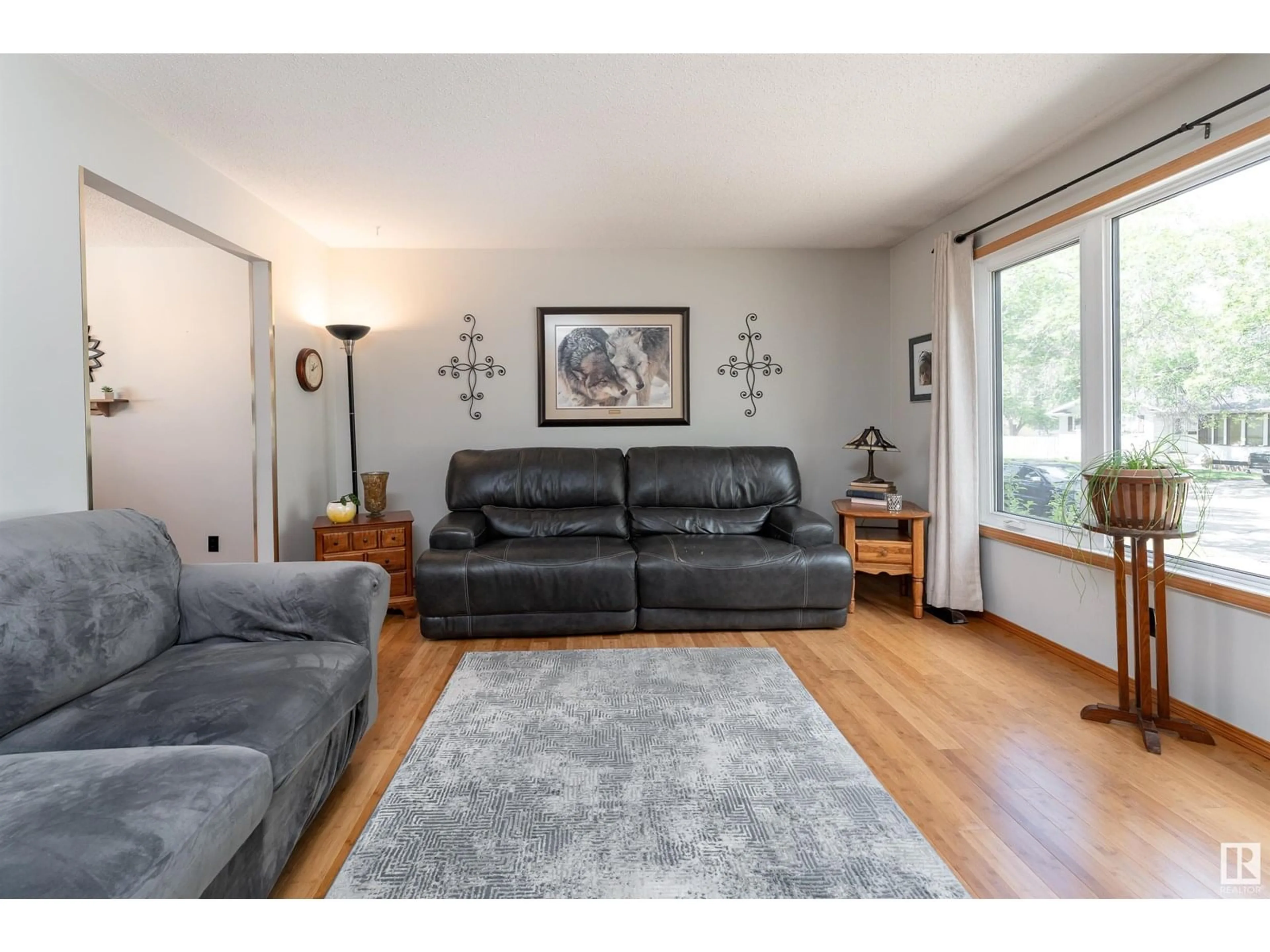 Living room with furniture, wood/laminate floor for 8513 92 AV, Fort Saskatchewan Alberta T8L1A1