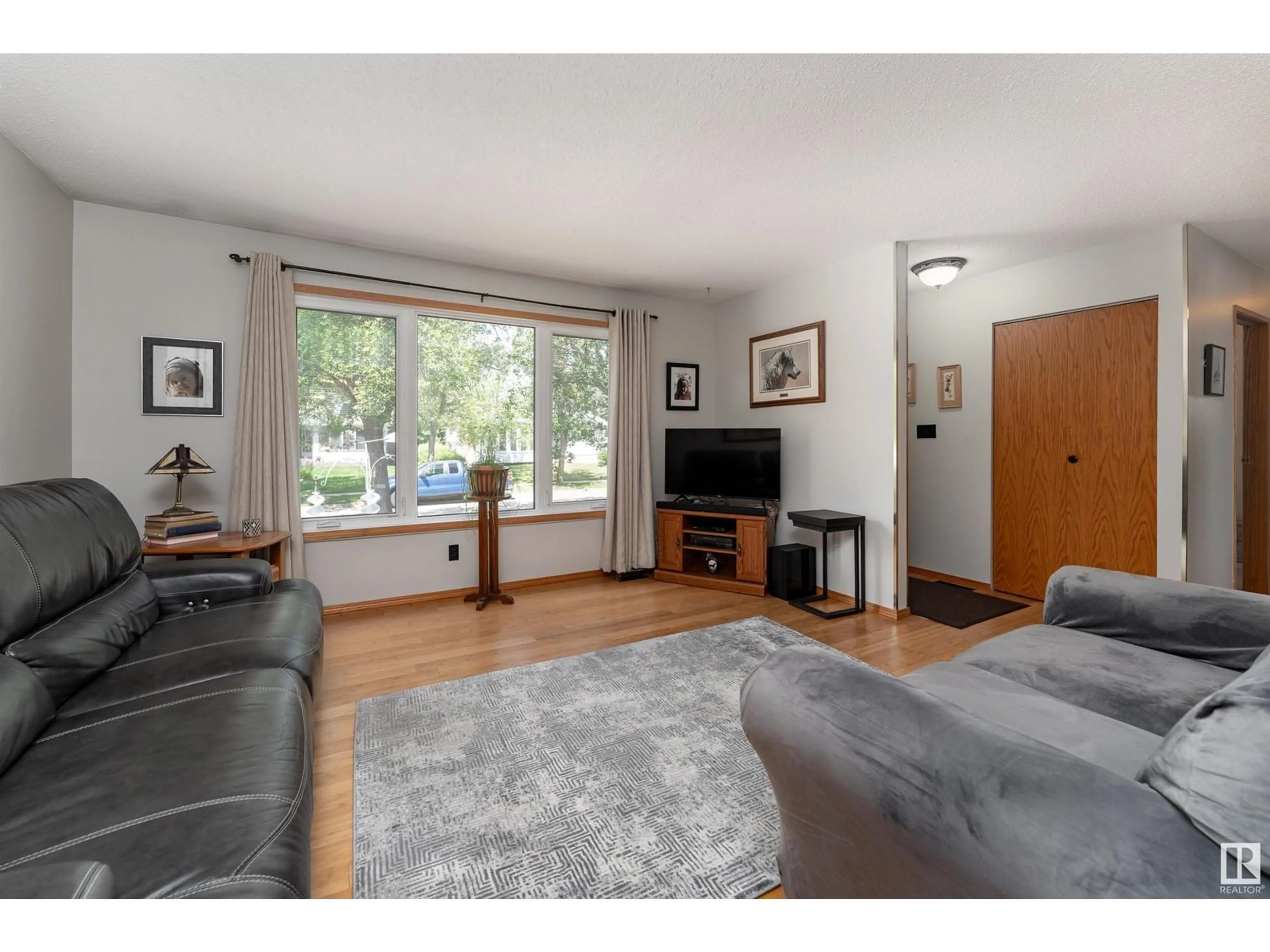 Living room with furniture, wood/laminate floor for 8513 92 AV, Fort Saskatchewan Alberta T8L1A1