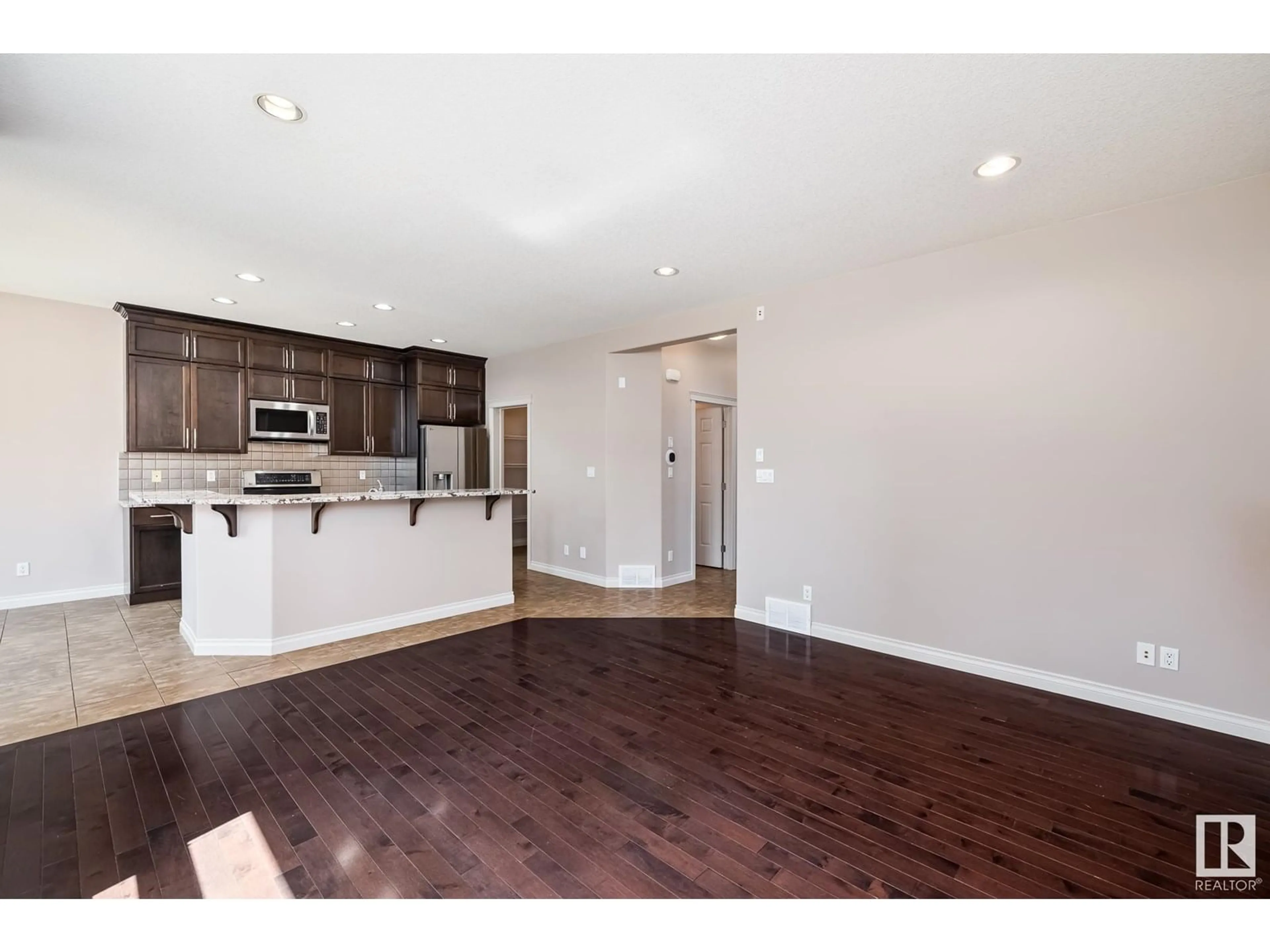 Open concept kitchen, wood/laminate floor for 22043 95 AV NW, Edmonton Alberta T5T4A7