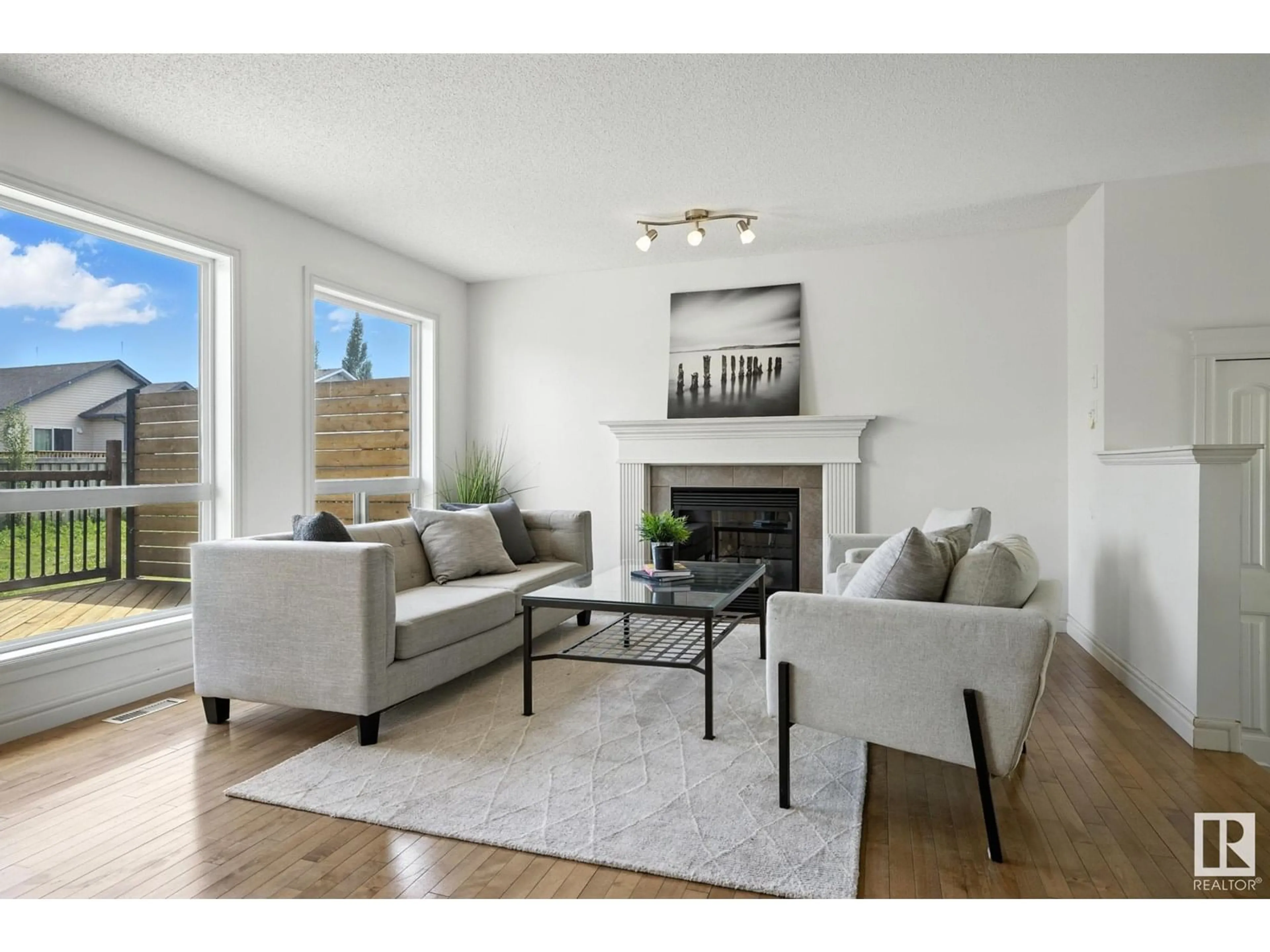 Living room with furniture, wood/laminate floor for NW - 4615 203 ST, Edmonton Alberta T6M0A6
