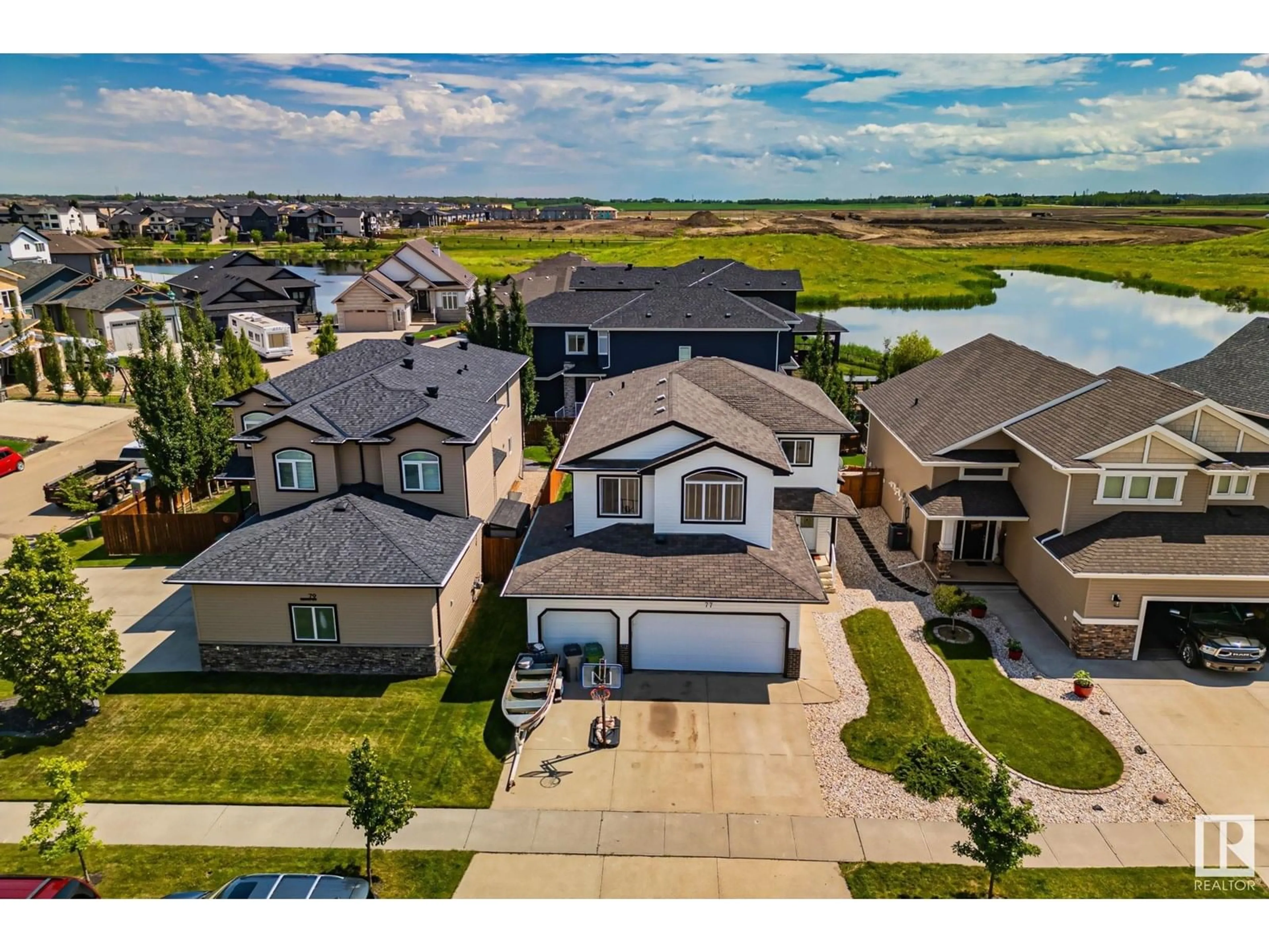 A pic from outside/outdoor area/front of a property/back of a property/a pic from drone, water/lake/river/ocean view for 77 LAKEWOOD BV, Beaumont Alberta T4X0B5