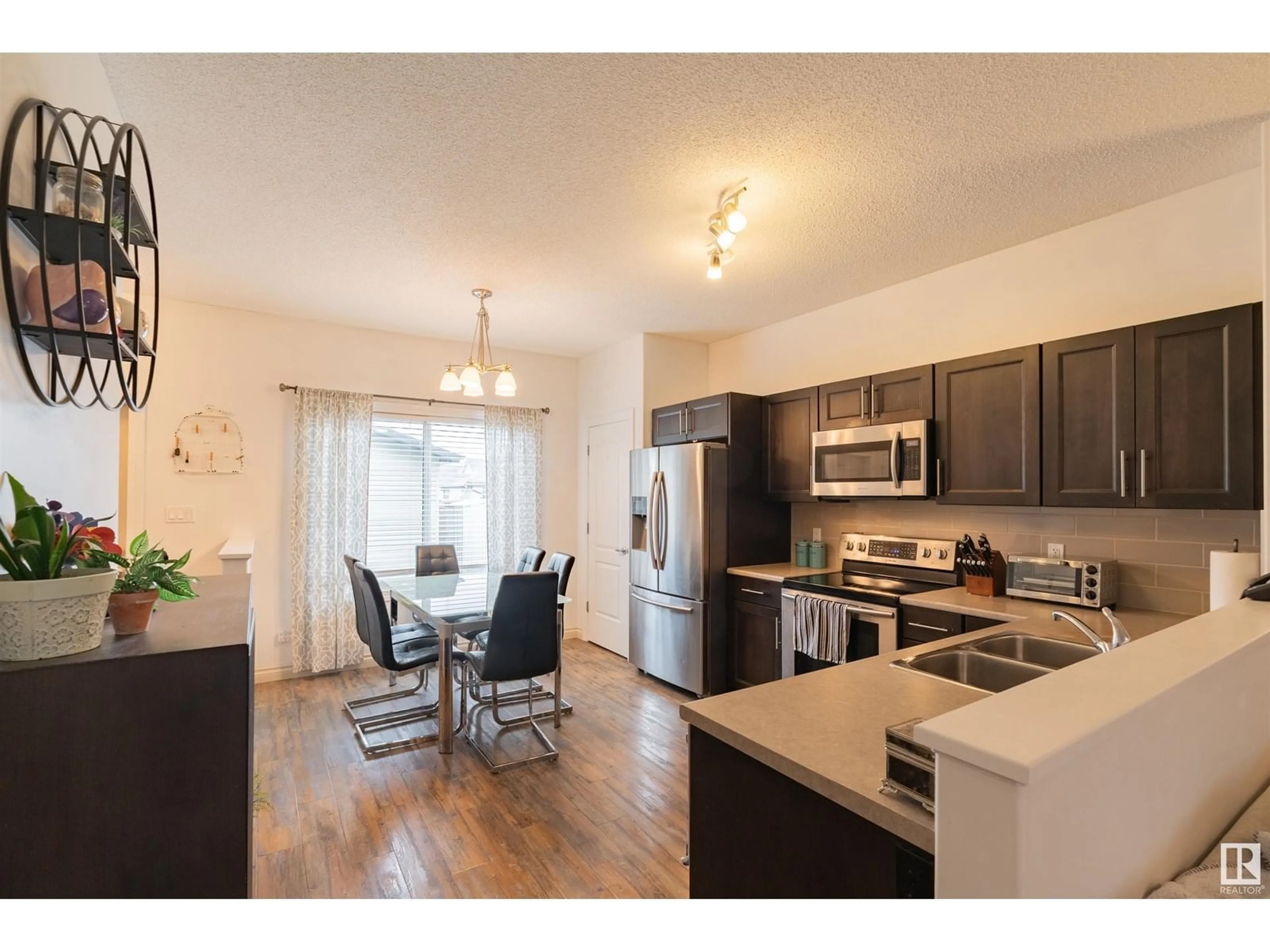 Open concept kitchen, wood/laminate floor for 16728 120 ST, Edmonton Alberta T5X0G5