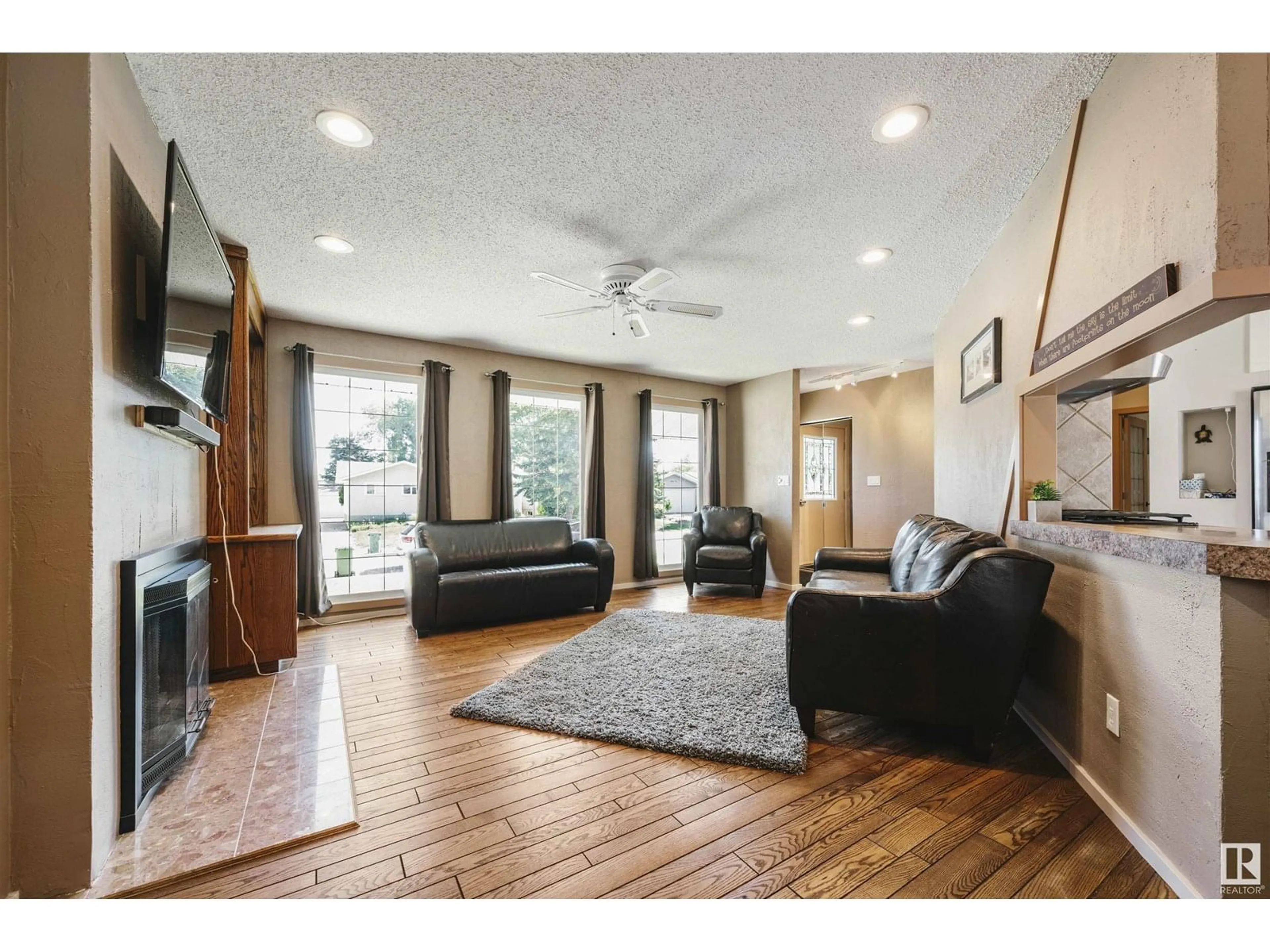 Living room with furniture, wood/laminate floor for 4415 54 AV, Beaumont Alberta T4X1J6