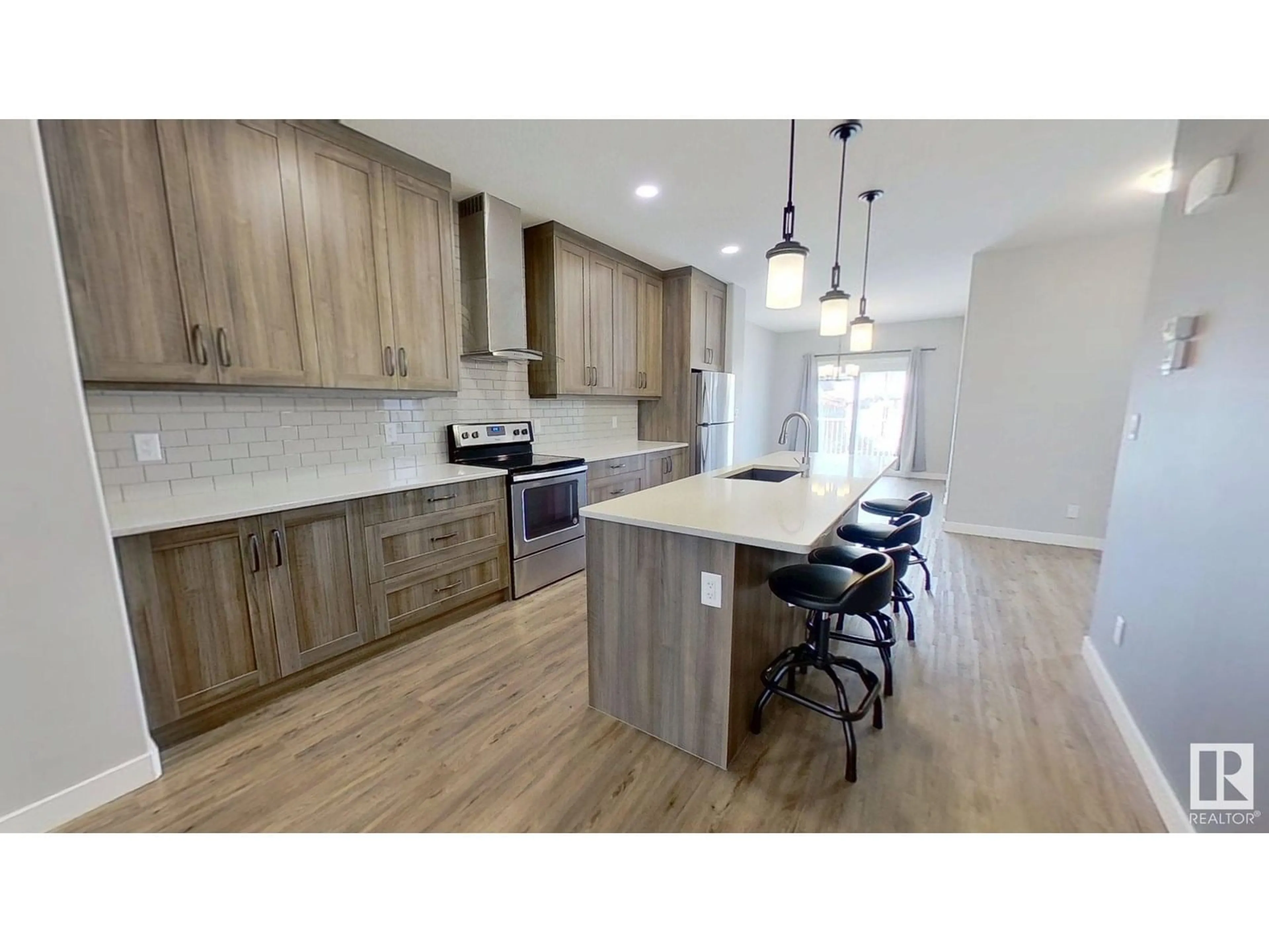 Open concept kitchen, wood/laminate floor for 8540 89 ST, Edmonton Alberta T6C3K3
