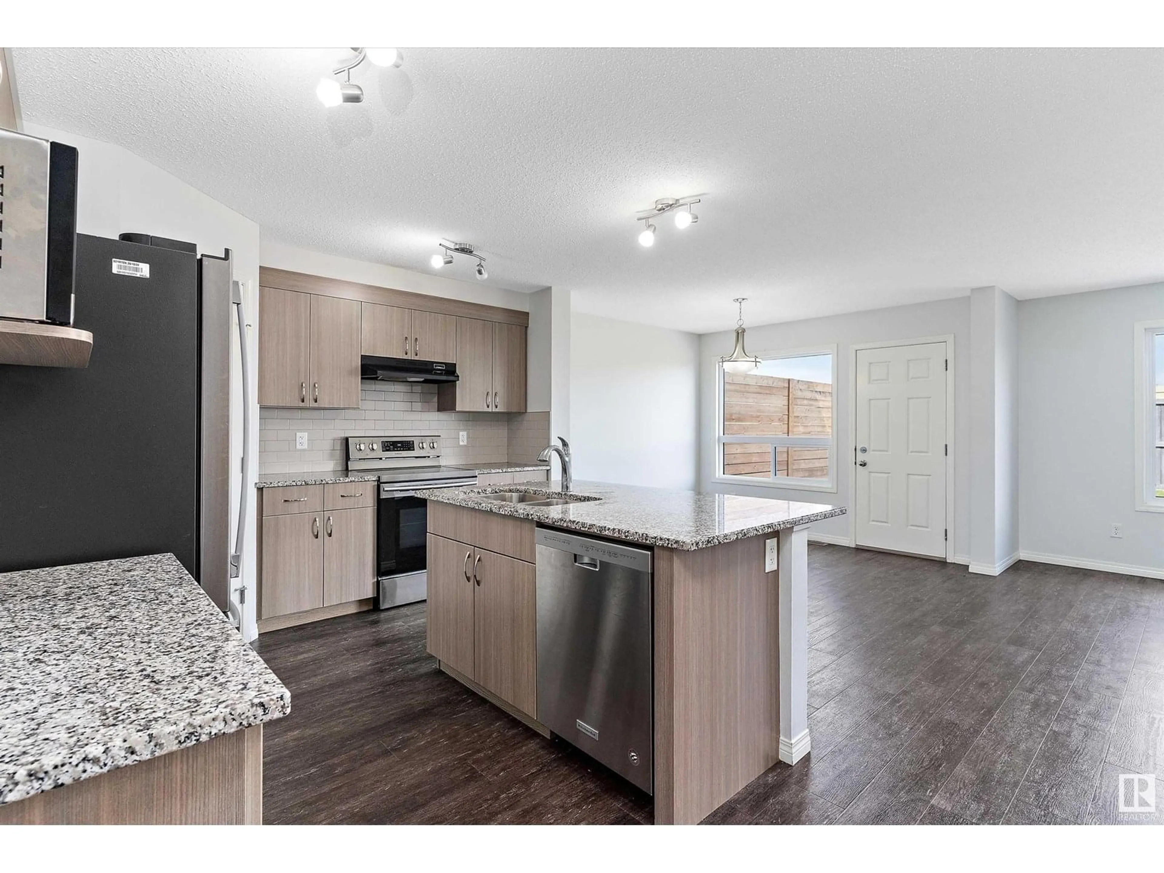 Open concept kitchen, wood/laminate floor for 17135 38 ST, Edmonton Alberta T5Z3R7