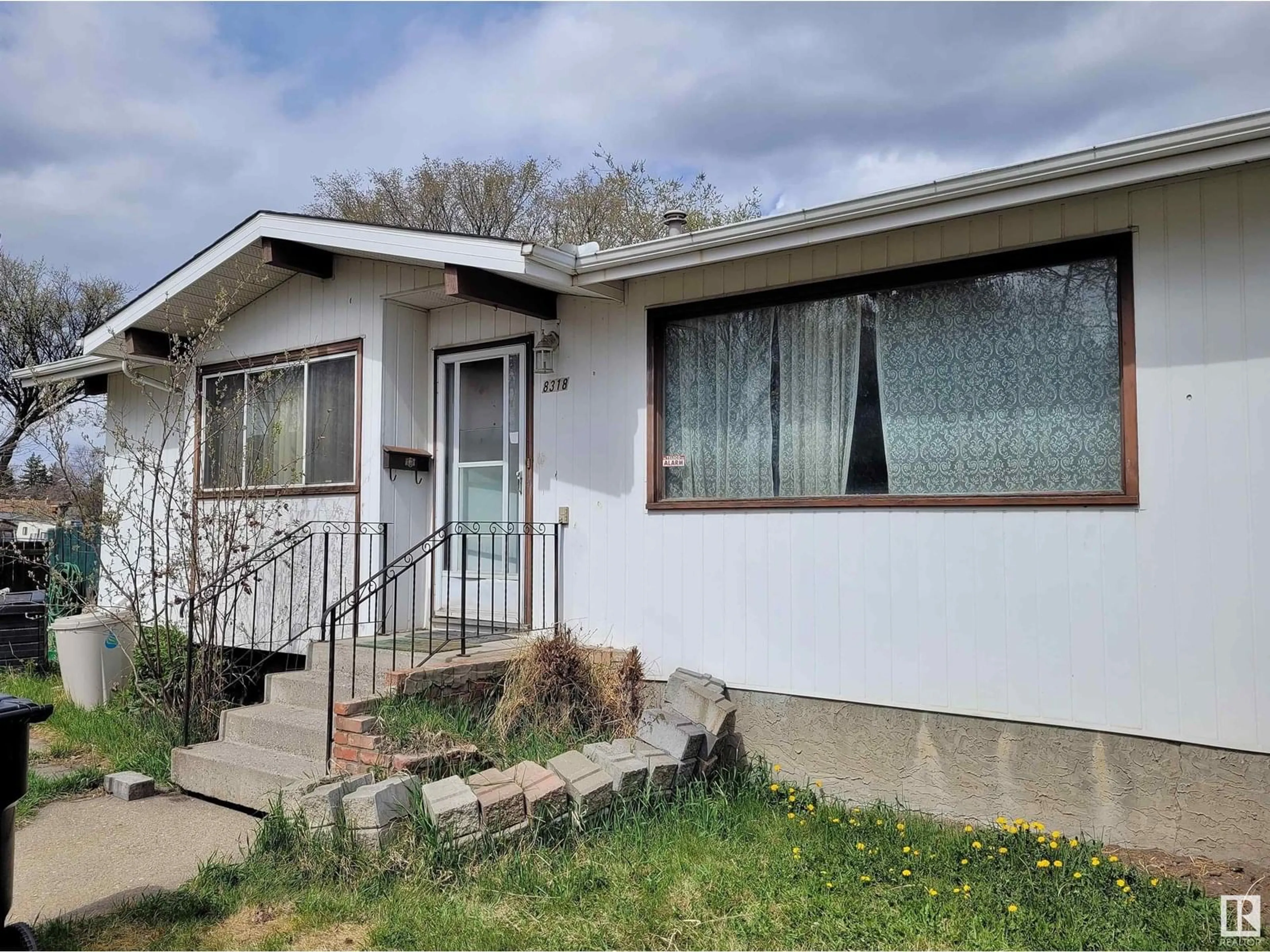 Home with vinyl exterior material, street for 8318 122 AV, Edmonton Alberta T5B4M7