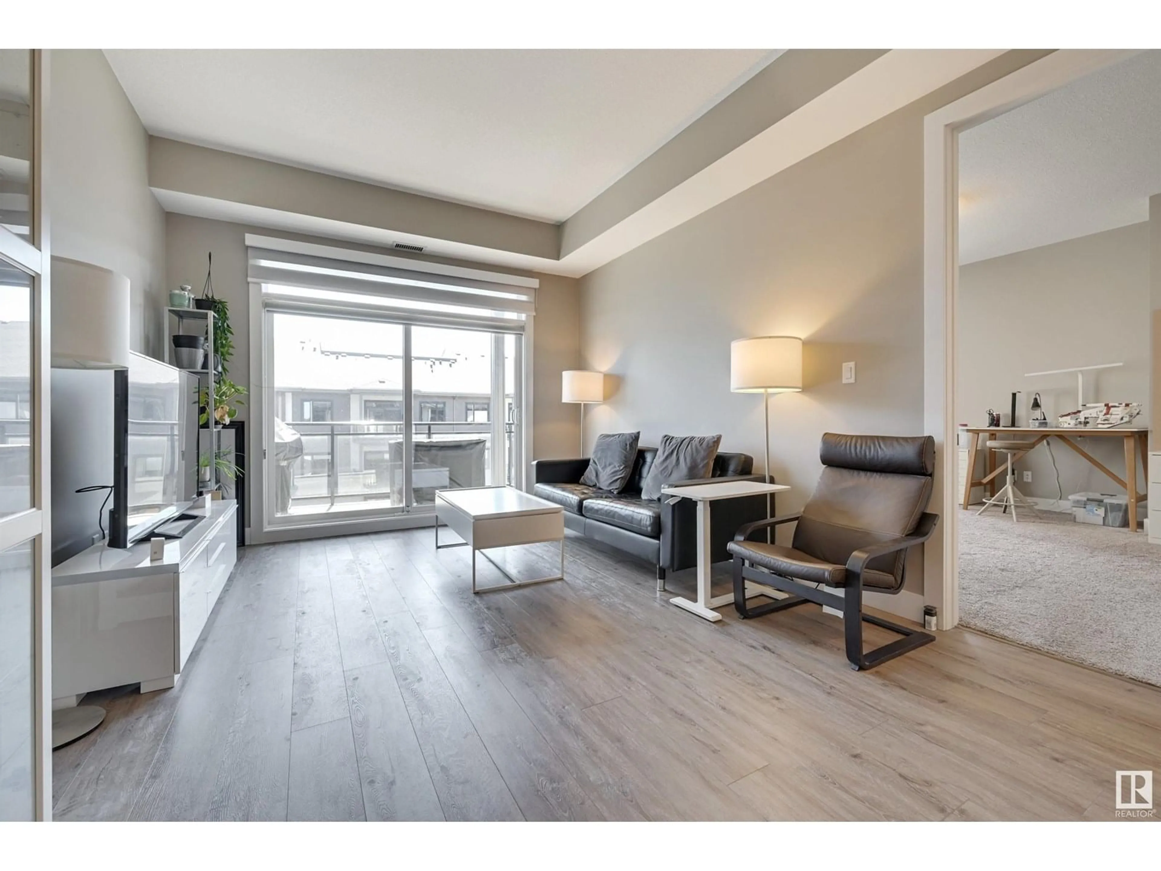 Living room with furniture, wood/laminate floor for #406 - 528 GRIESBACH PARADE, Edmonton Alberta T5E6X2