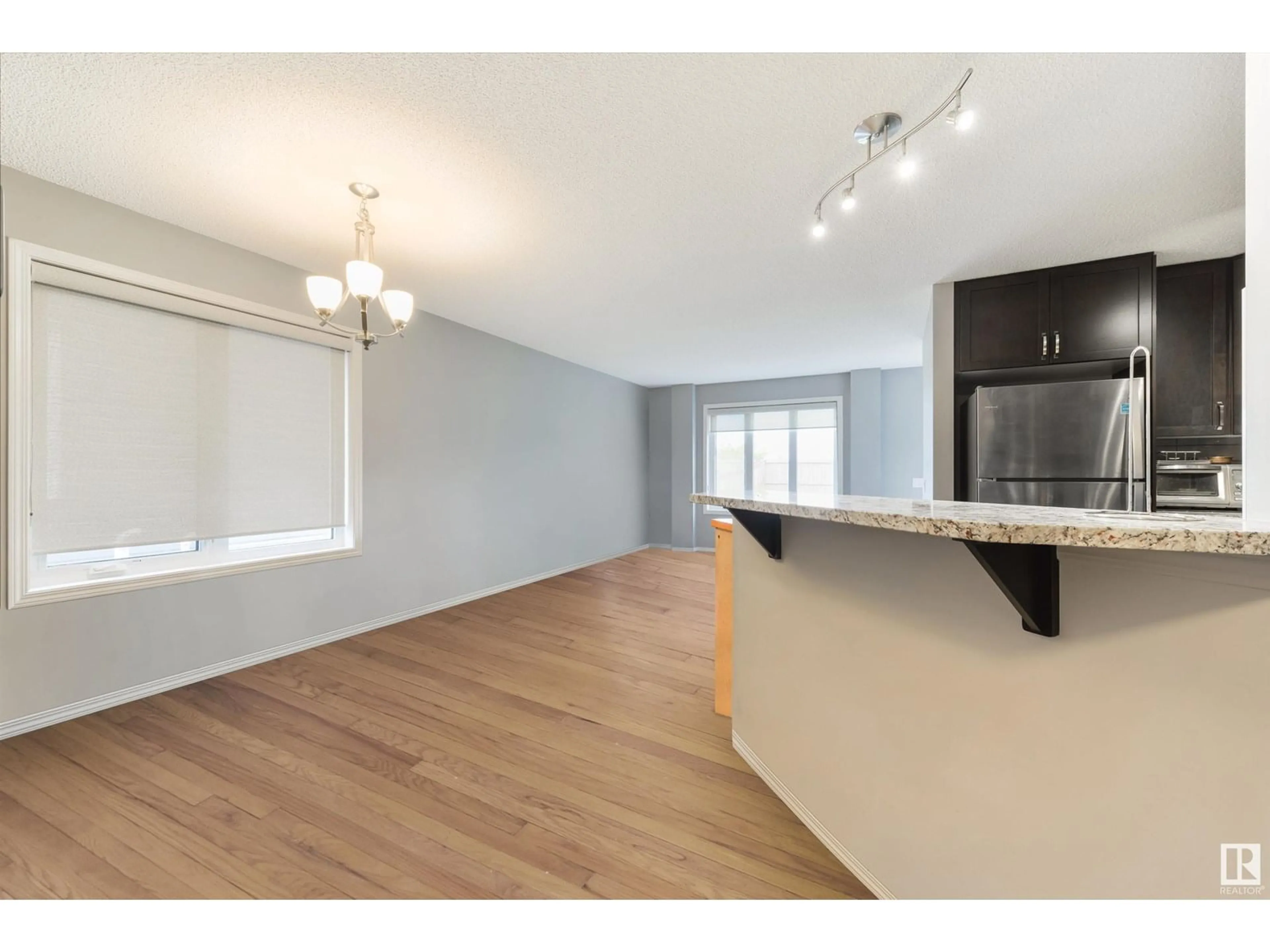 Open concept kitchen, wood/laminate floor for 7161 CARDINAL WY, Edmonton Alberta T6W2Y3