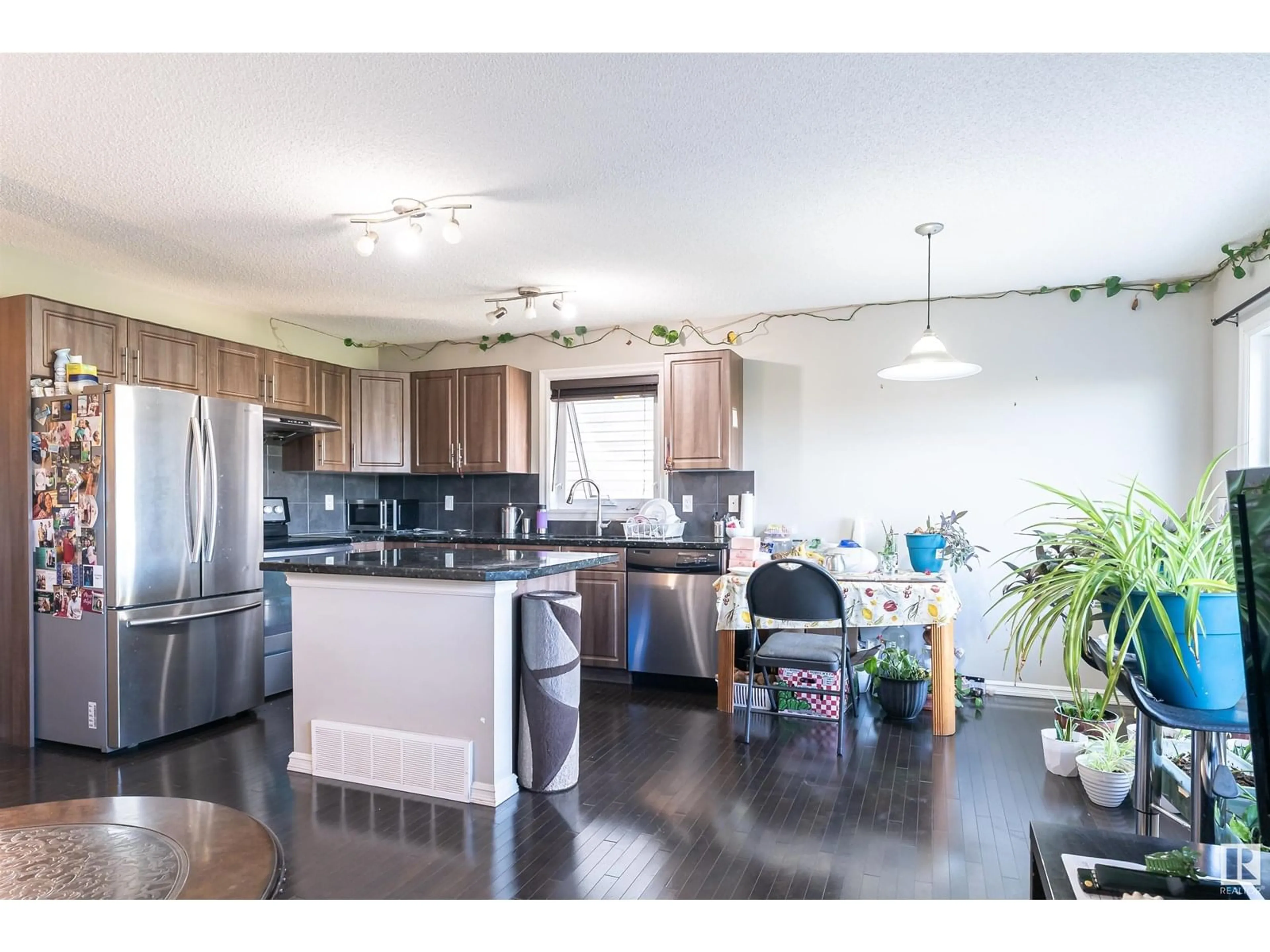 Open concept kitchen, wood/laminate floor for NW - 1841 28 ST, Edmonton Alberta T6T0N8