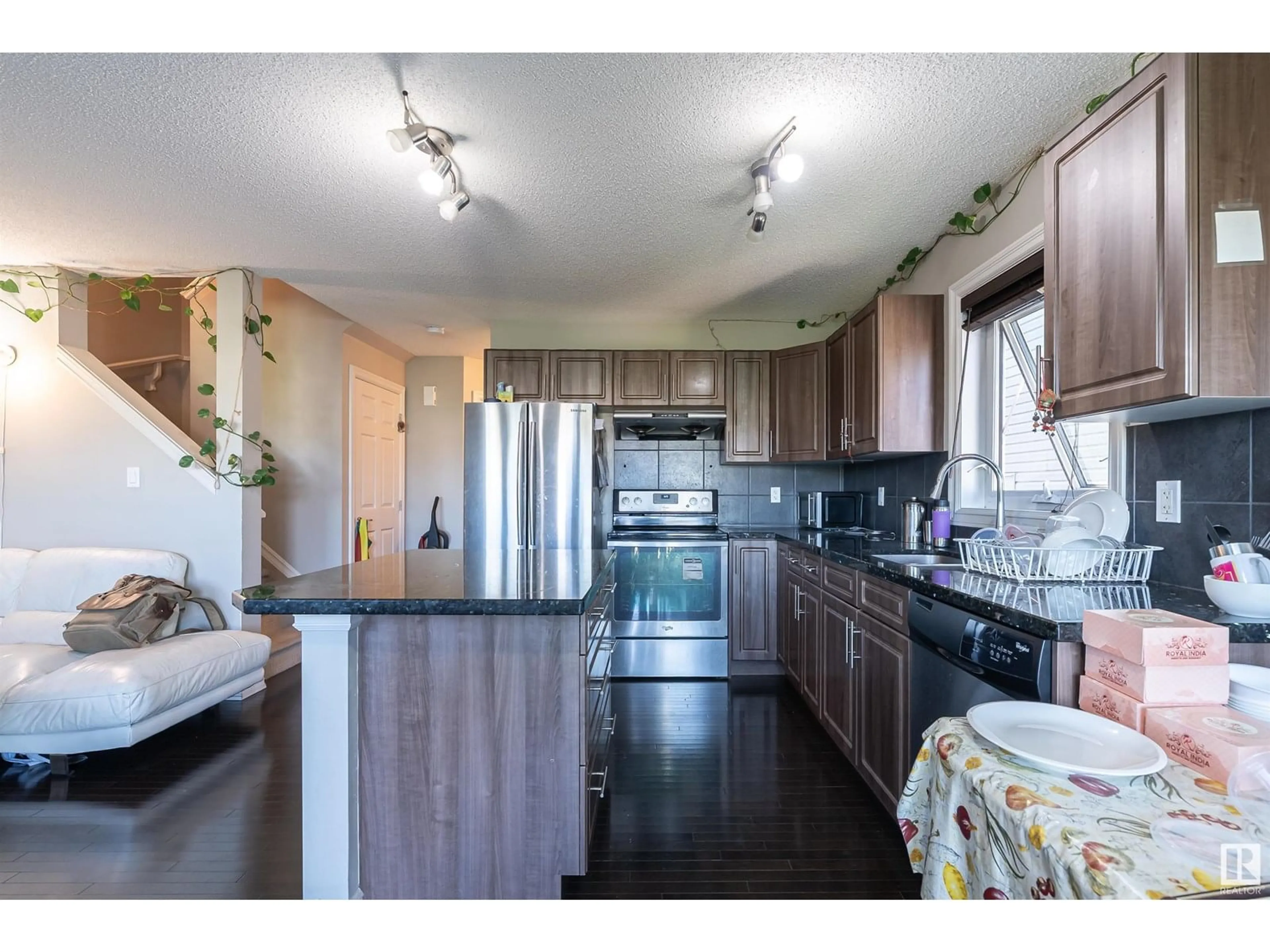 Open concept kitchen, wood/laminate floor for NW - 1841 28 ST, Edmonton Alberta T6T0N8