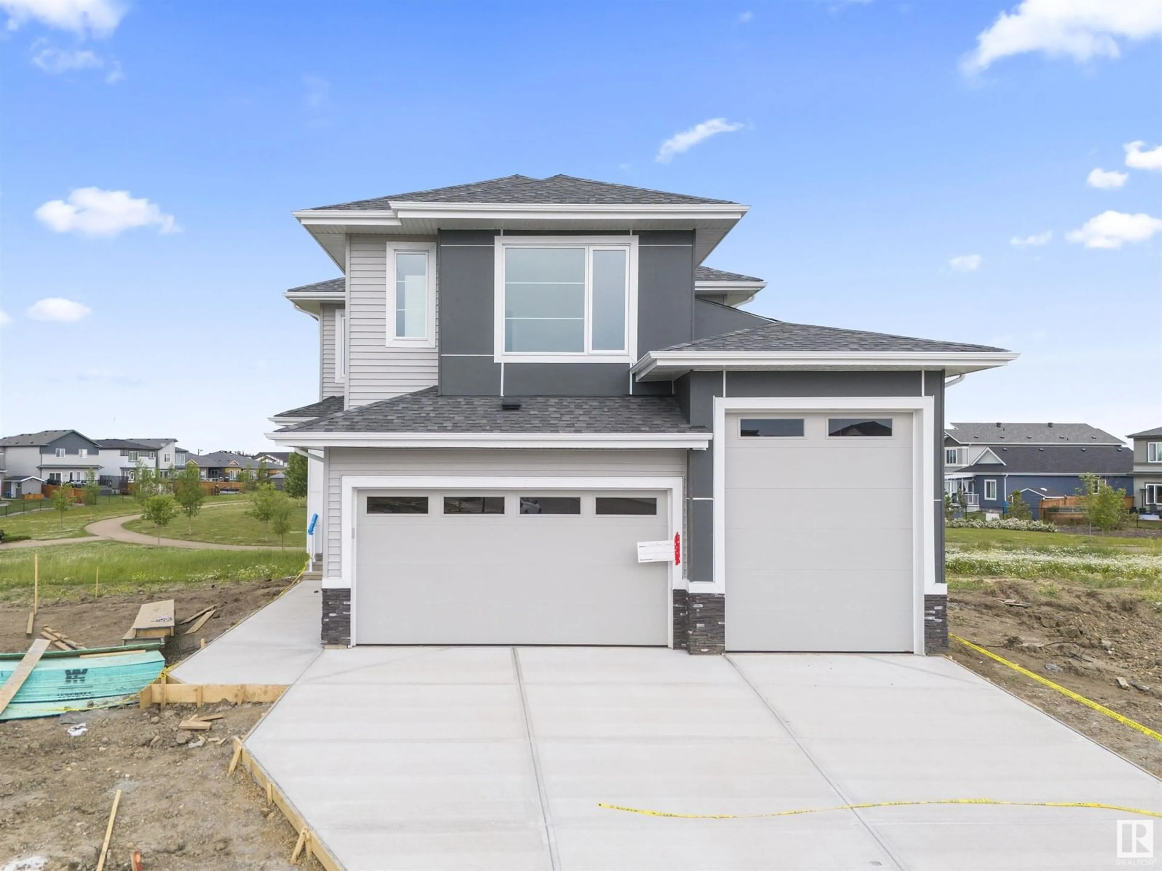 Home with vinyl exterior material, street for 216 BASIN CO, Leduc Alberta T2R0A2