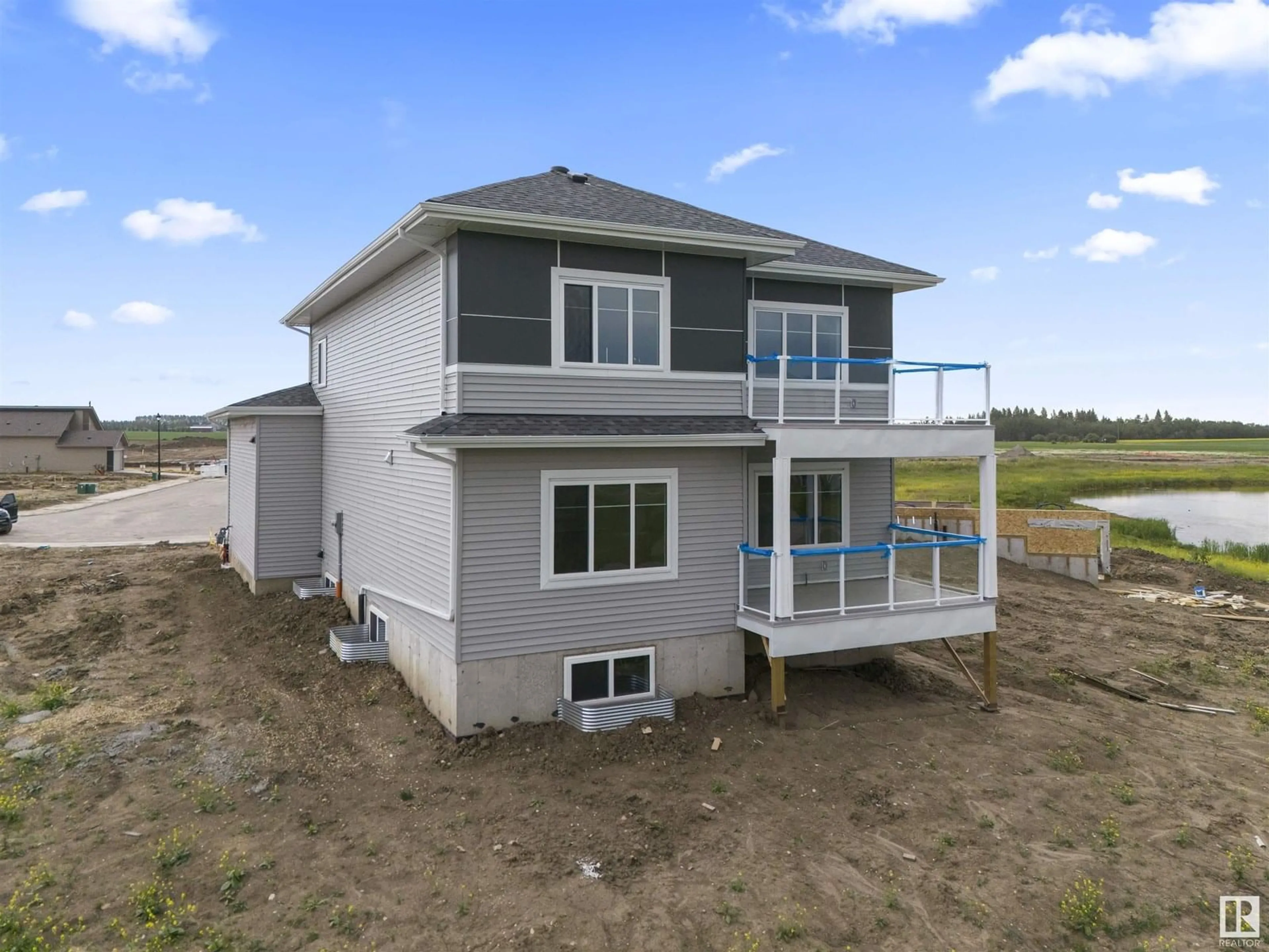 Home with vinyl exterior material, water/lake/river/ocean view for 216 BASIN CO, Leduc Alberta T2R0A2