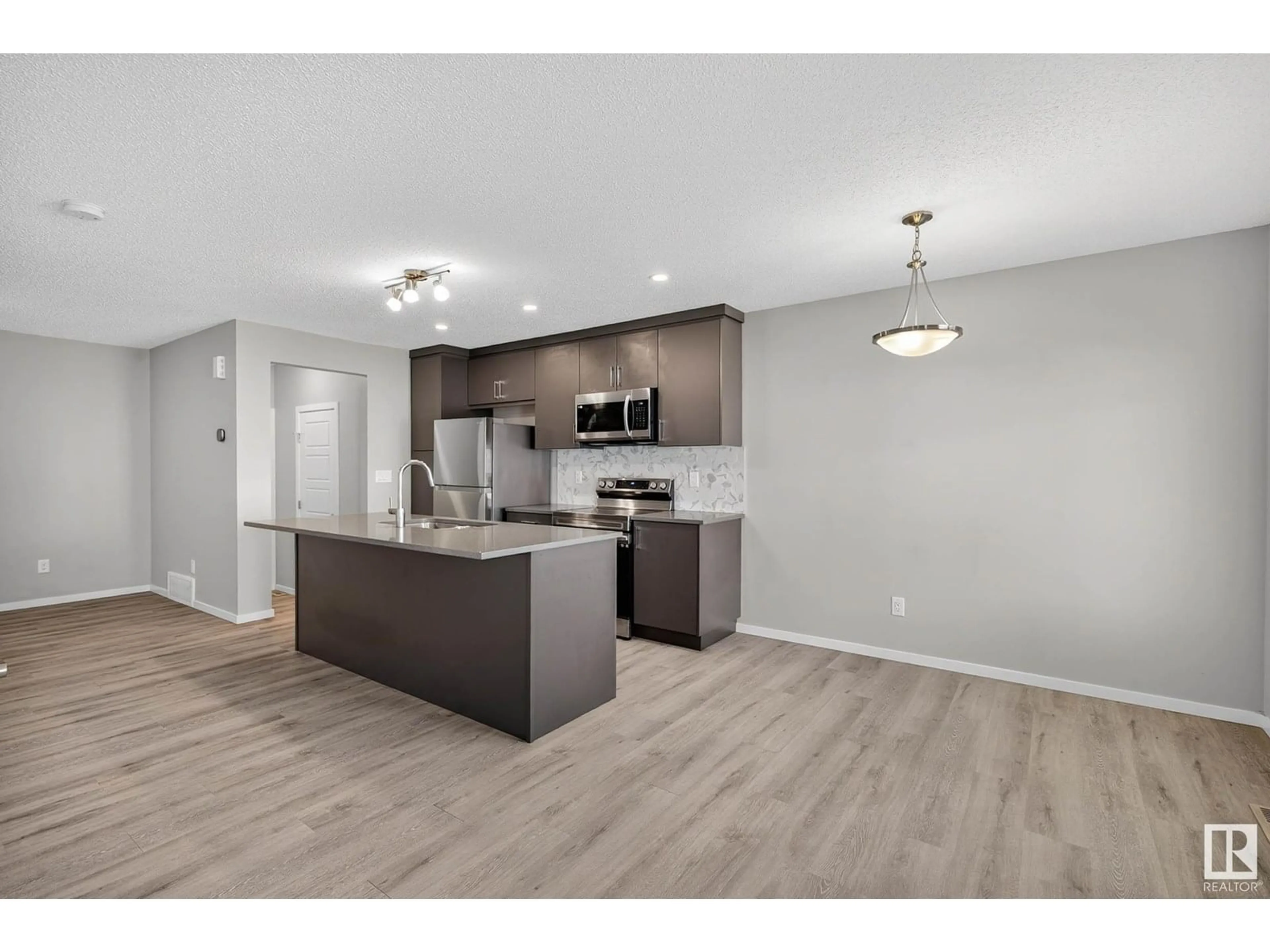Open concept kitchen, wood/laminate floor for 20423 21 AV, Edmonton Alberta T6M1M8
