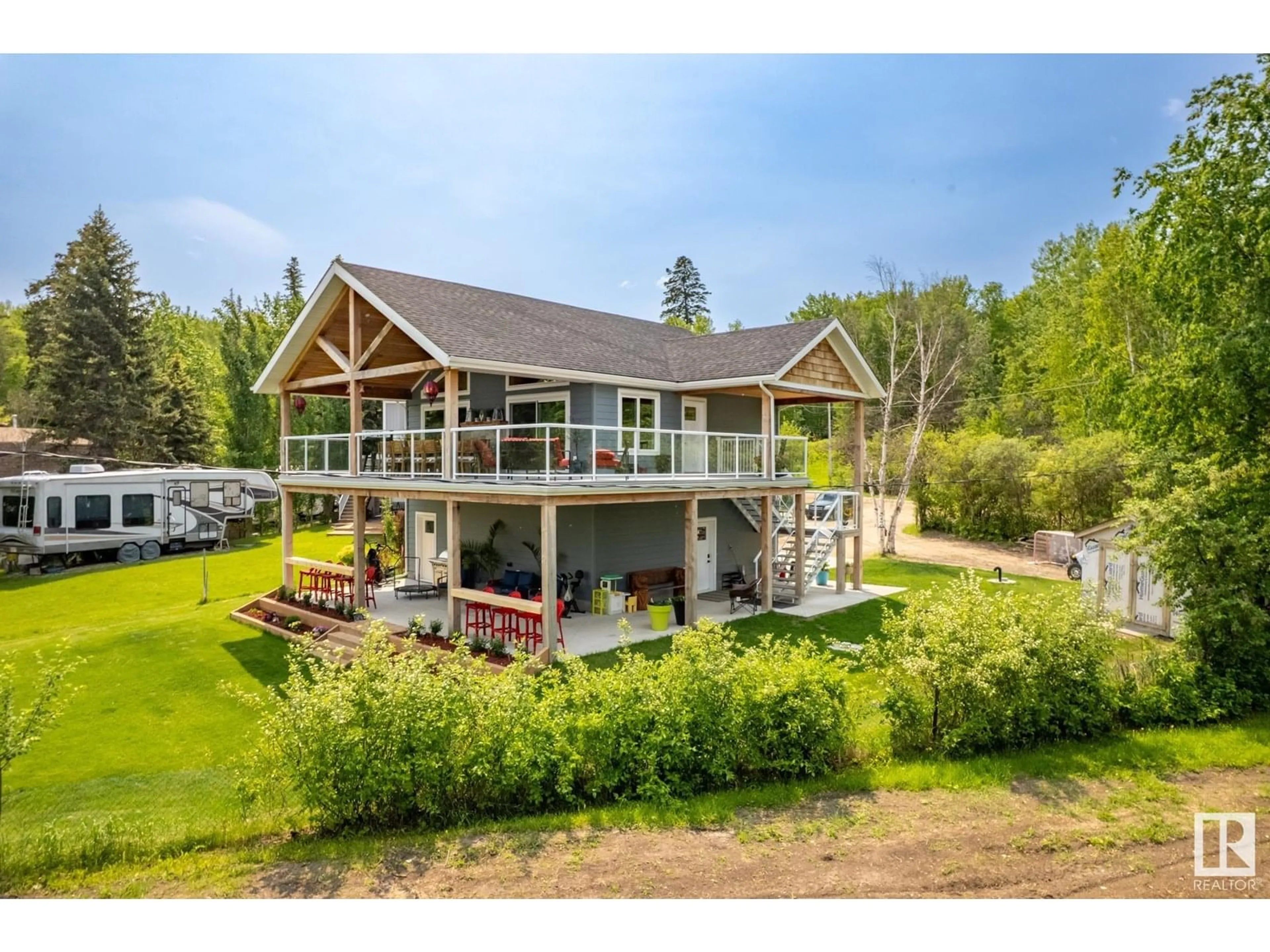 A pic from outside/outdoor area/front of a property/back of a property/a pic from drone, water/lake/river/ocean view for 3215 TWP ROAD 574, Rural Lac Ste. Anne County Alberta T0E0N0