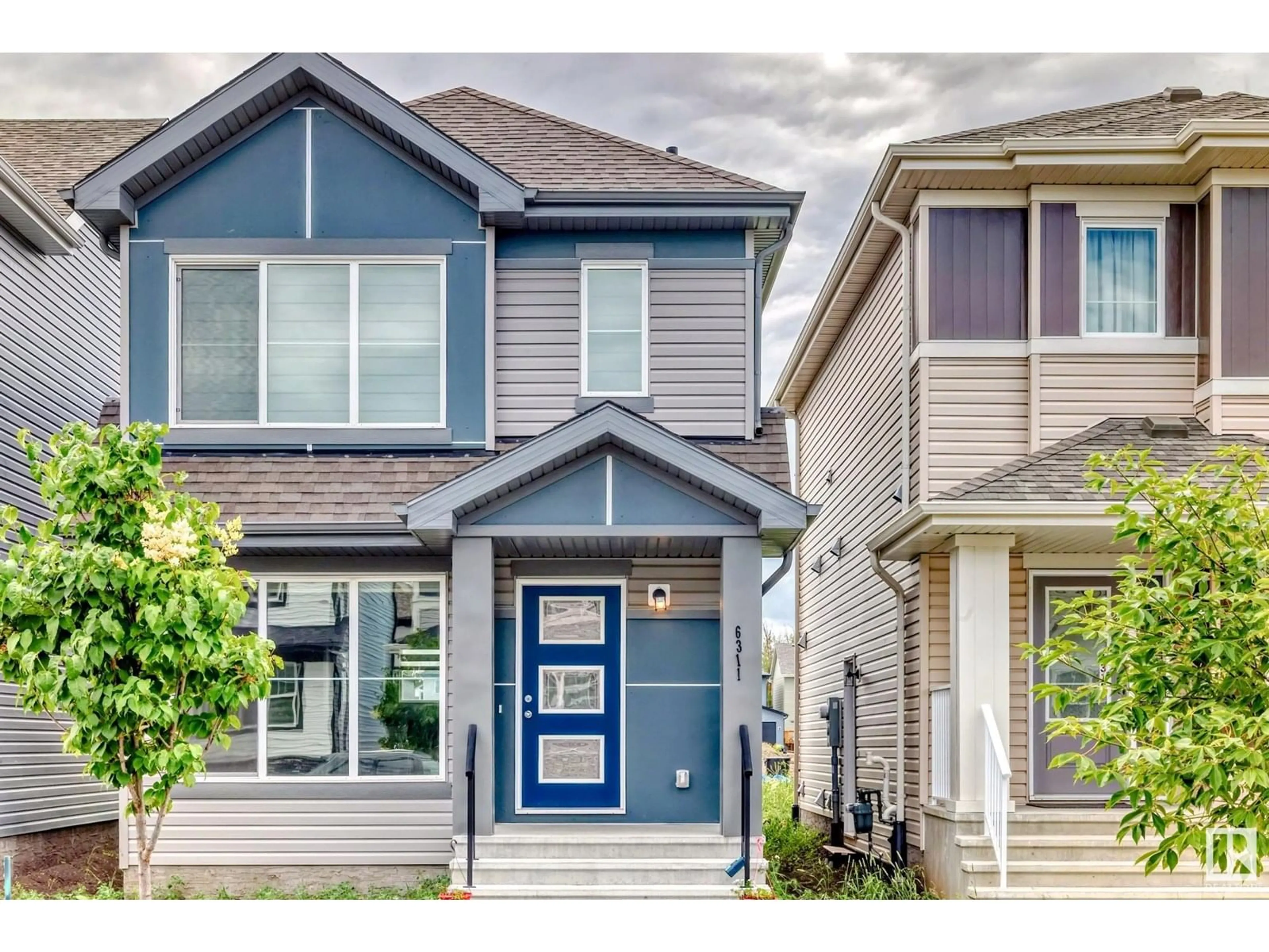 Home with vinyl exterior material, street for 6311 176 AV, Edmonton Alberta T5Y4E5
