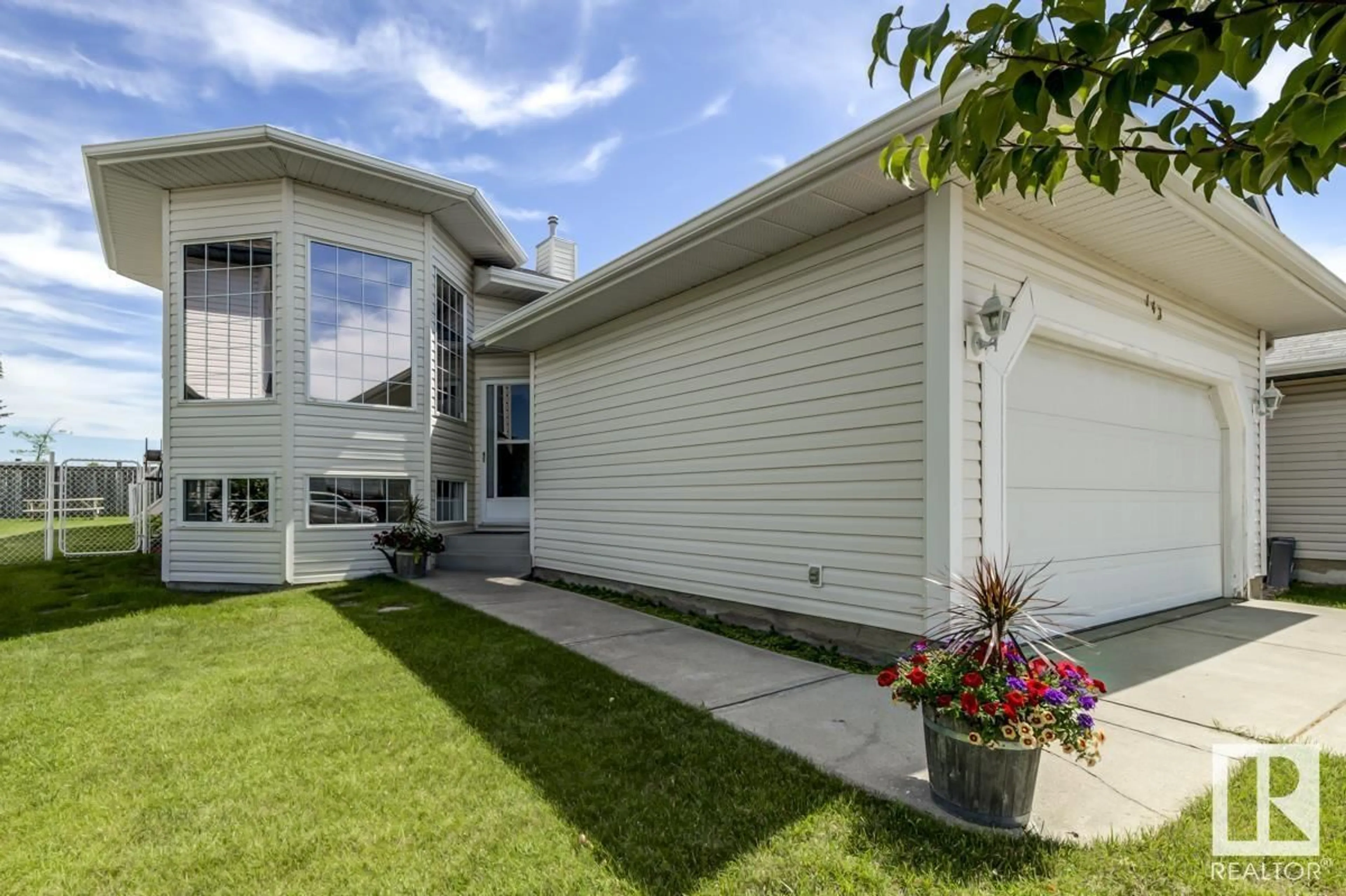 Home with vinyl exterior material, street for 143 HOLLICK-KENYON WY, Edmonton Alberta T5Y2V7