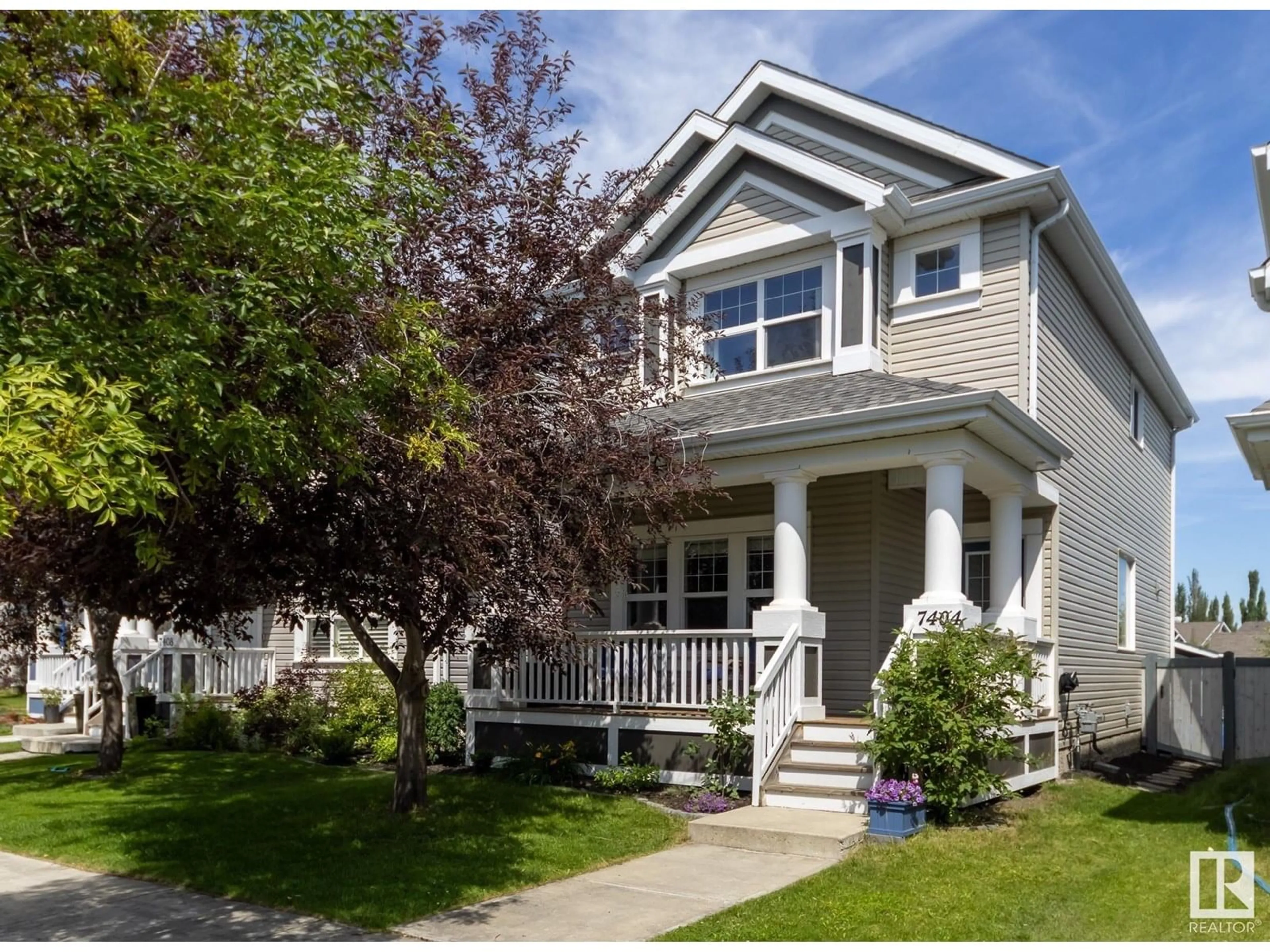 Home with vinyl exterior material, street for 7404 15A AV SW, Edmonton Alberta T6X0E1