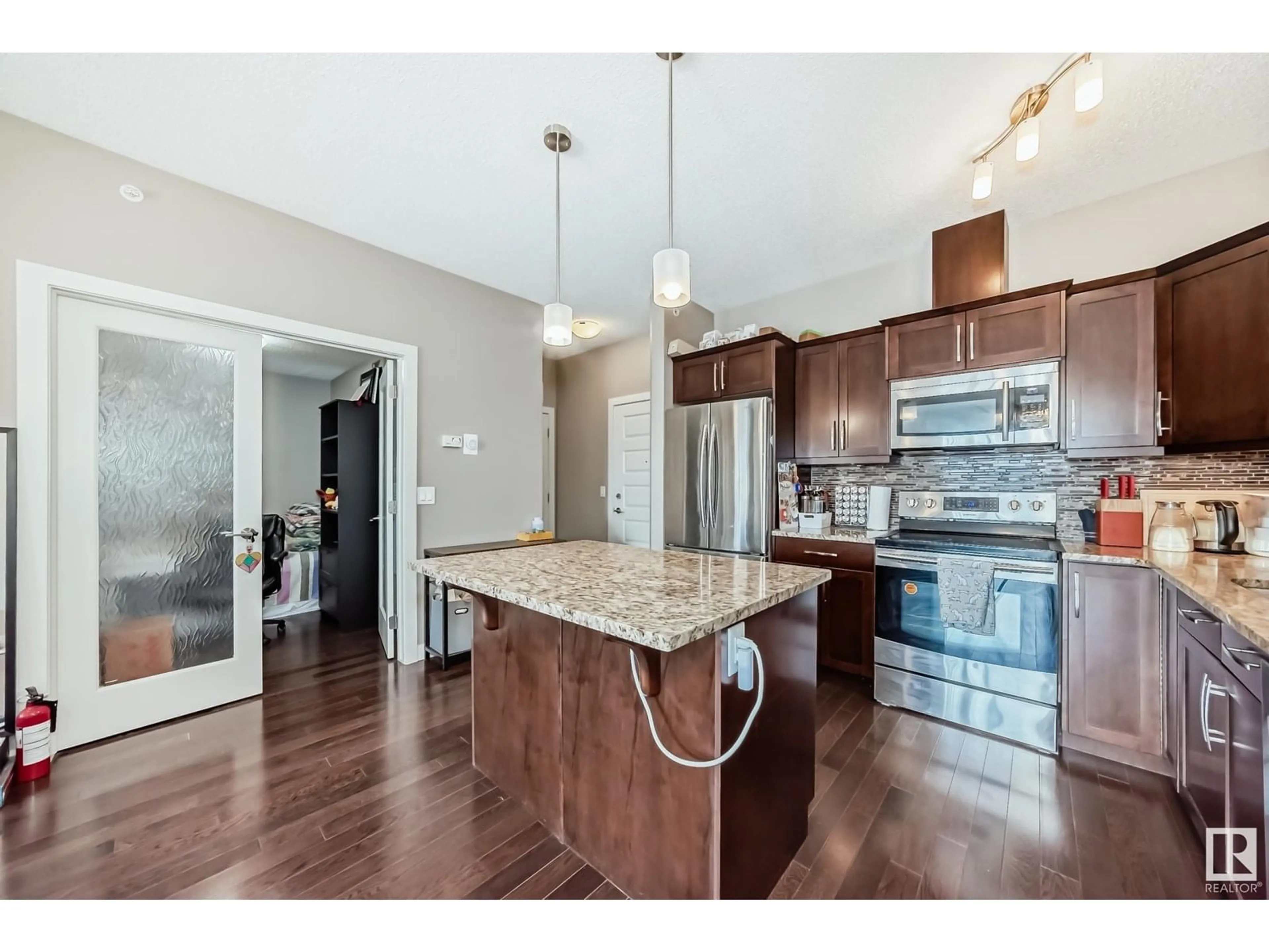 Open concept kitchen, wood/laminate floor for #417 - 10530 56 AV, Edmonton Alberta T6H0X7