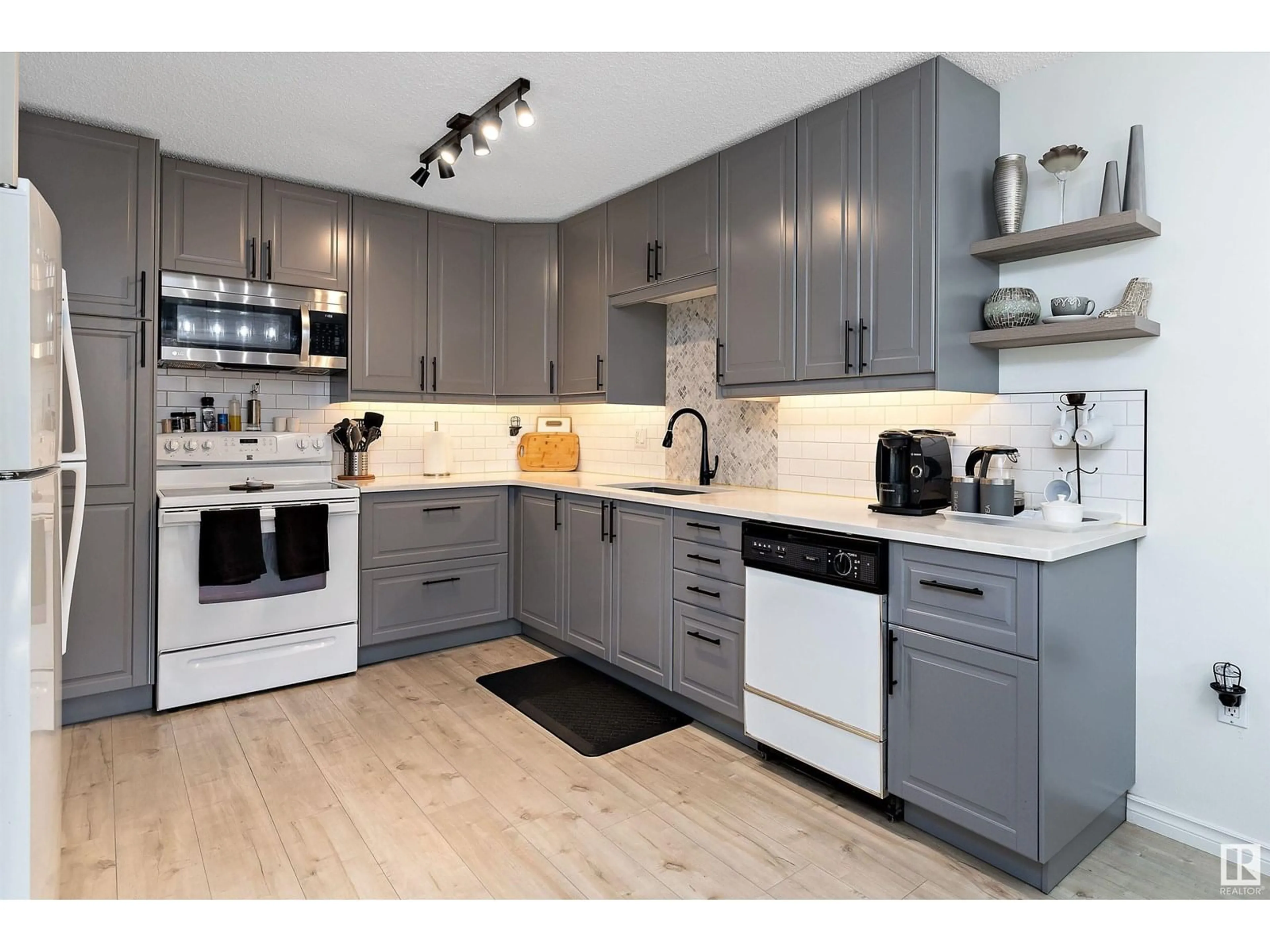Open concept kitchen, wood/laminate floor for 212 - 15499 CASTLE DOWNS RD, Edmonton Alberta T5X5Y3