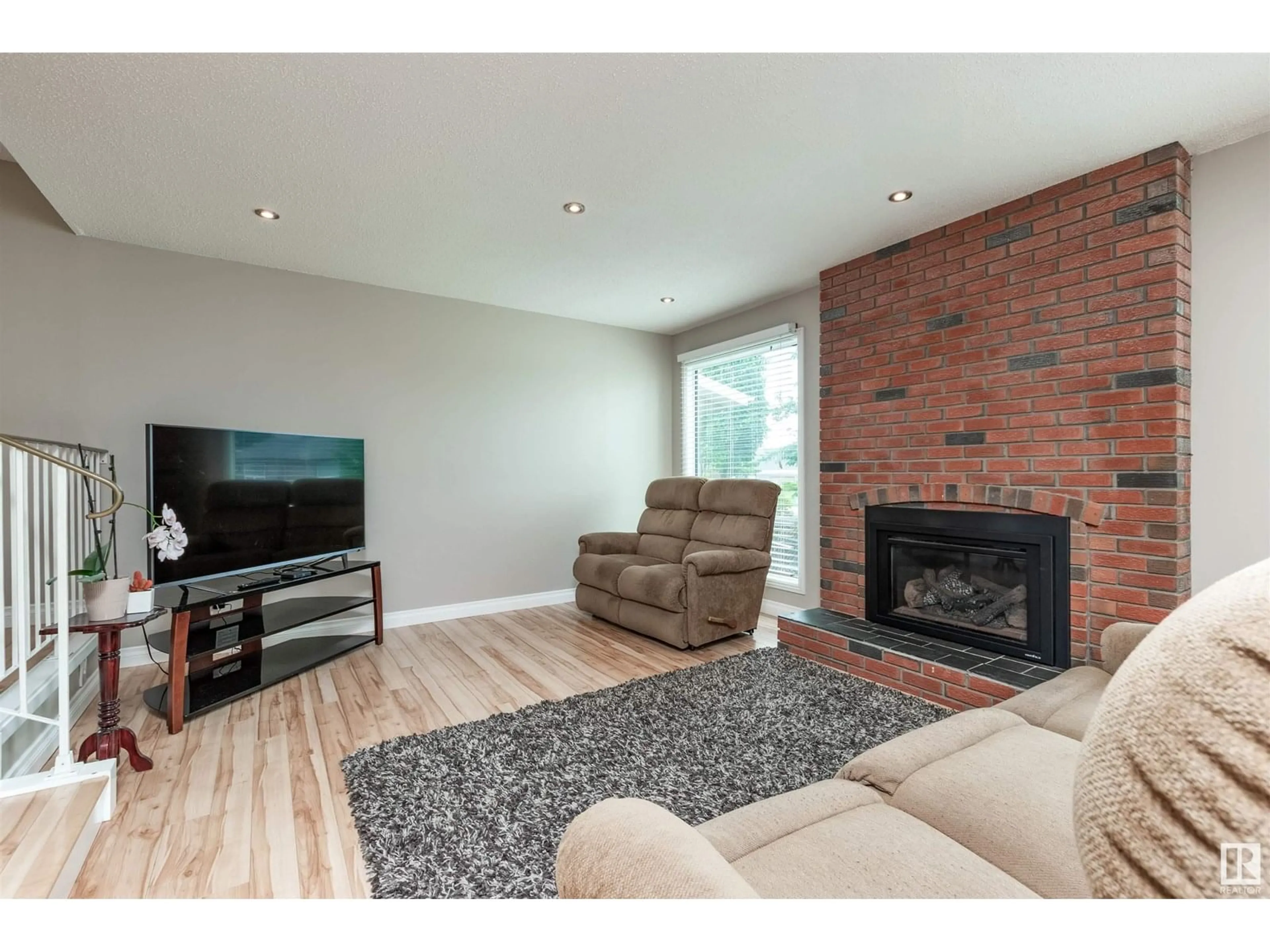 Living room with furniture, wood/laminate floor for 13840 30 ST, Edmonton Alberta T5Y1M5