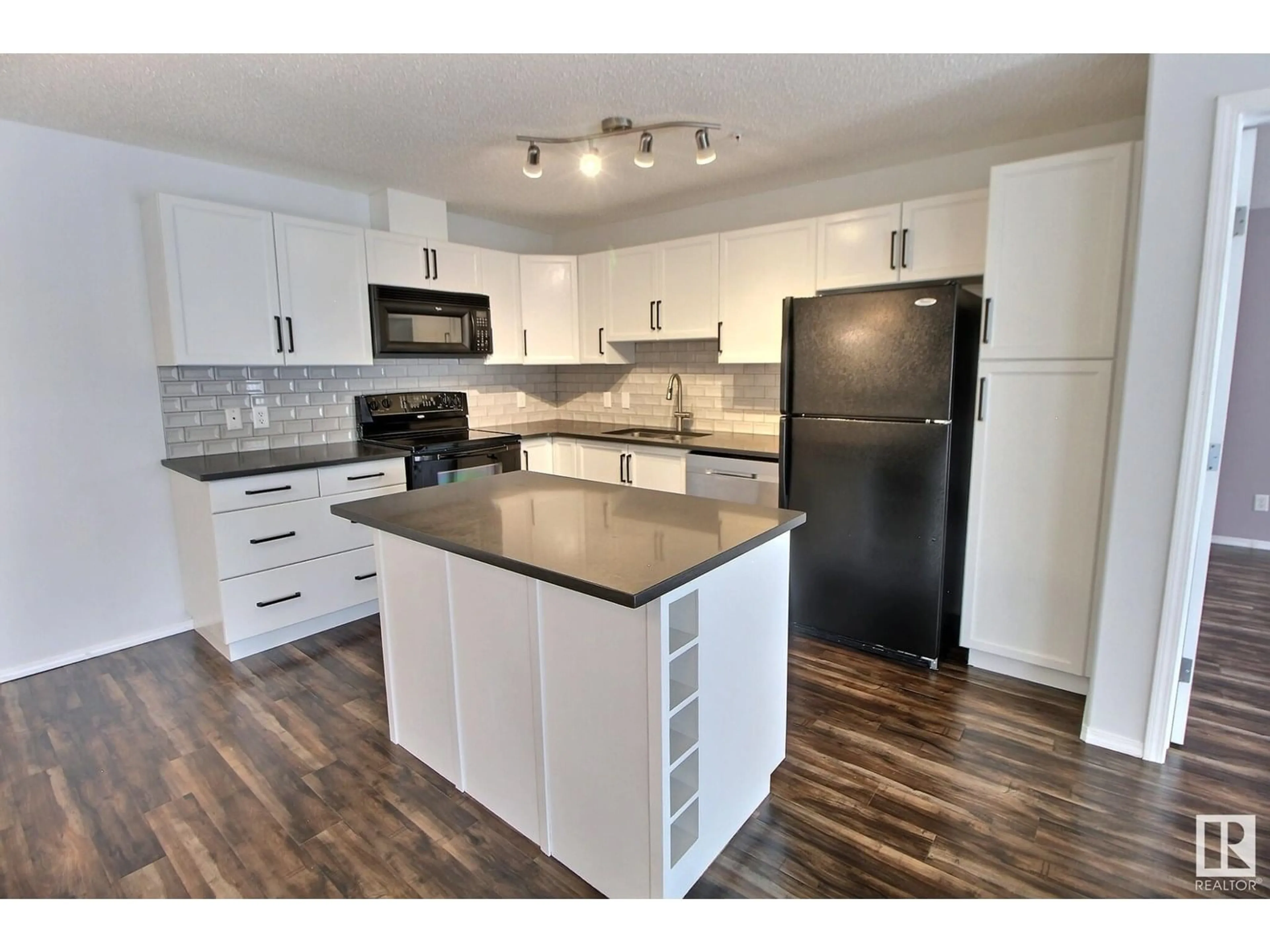 Open concept kitchen, wood/laminate floor for 228 16035 132 ST NW, Edmonton Alberta T6V0B4