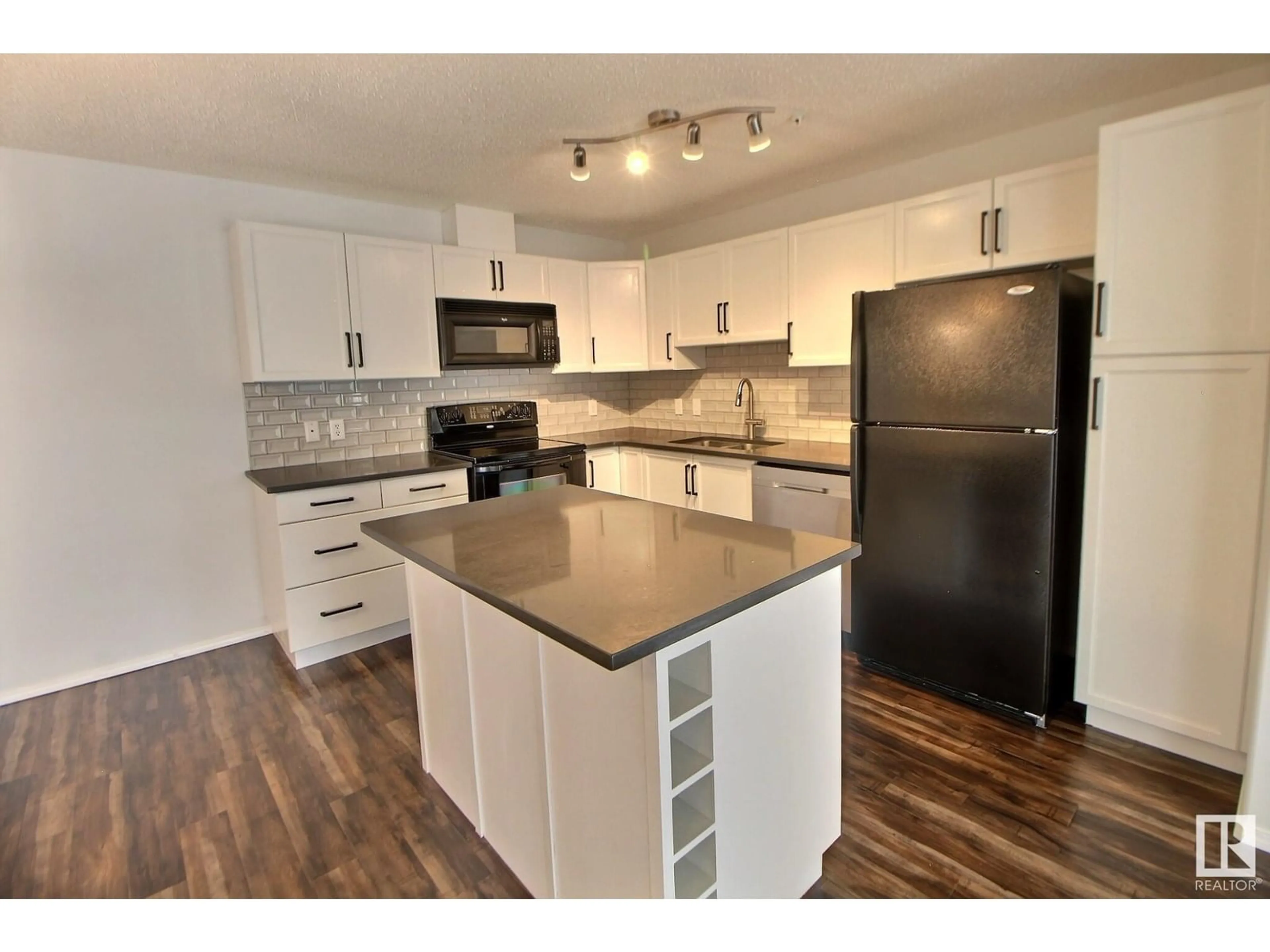 Open concept kitchen, wood/laminate floor for 228 16035 132 ST NW, Edmonton Alberta T6V0B4