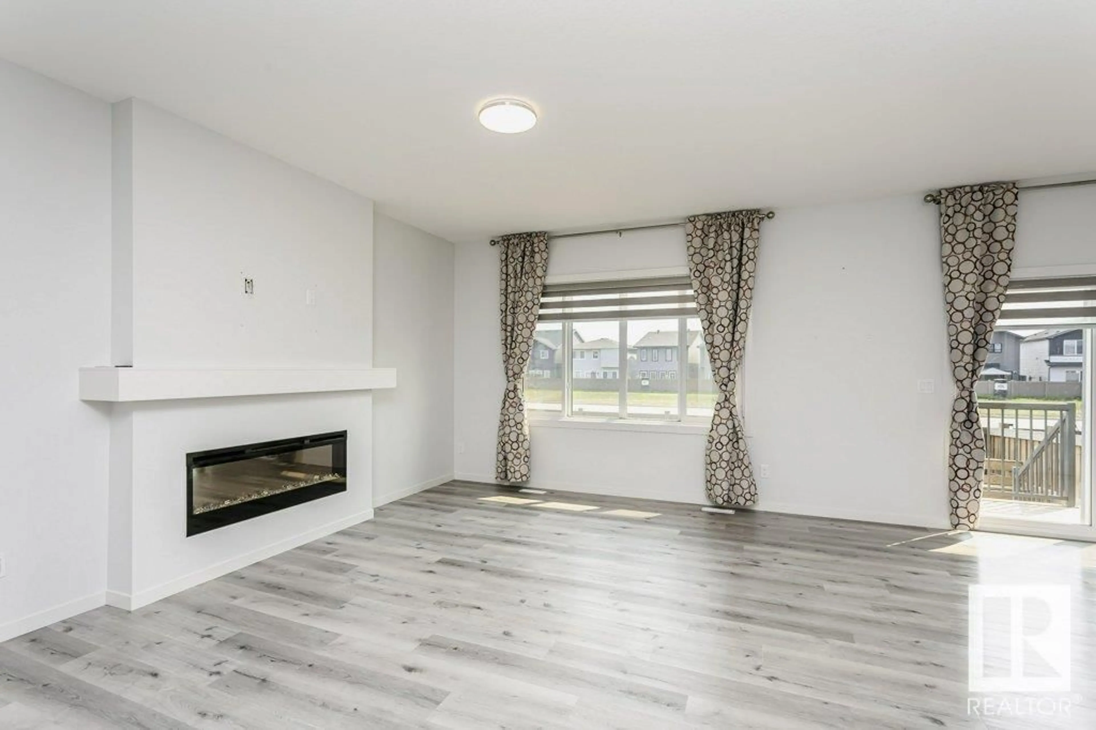 Living room with furniture, wood/laminate floor for NW - 2627 200 ST, Edmonton Alberta T6M1K3