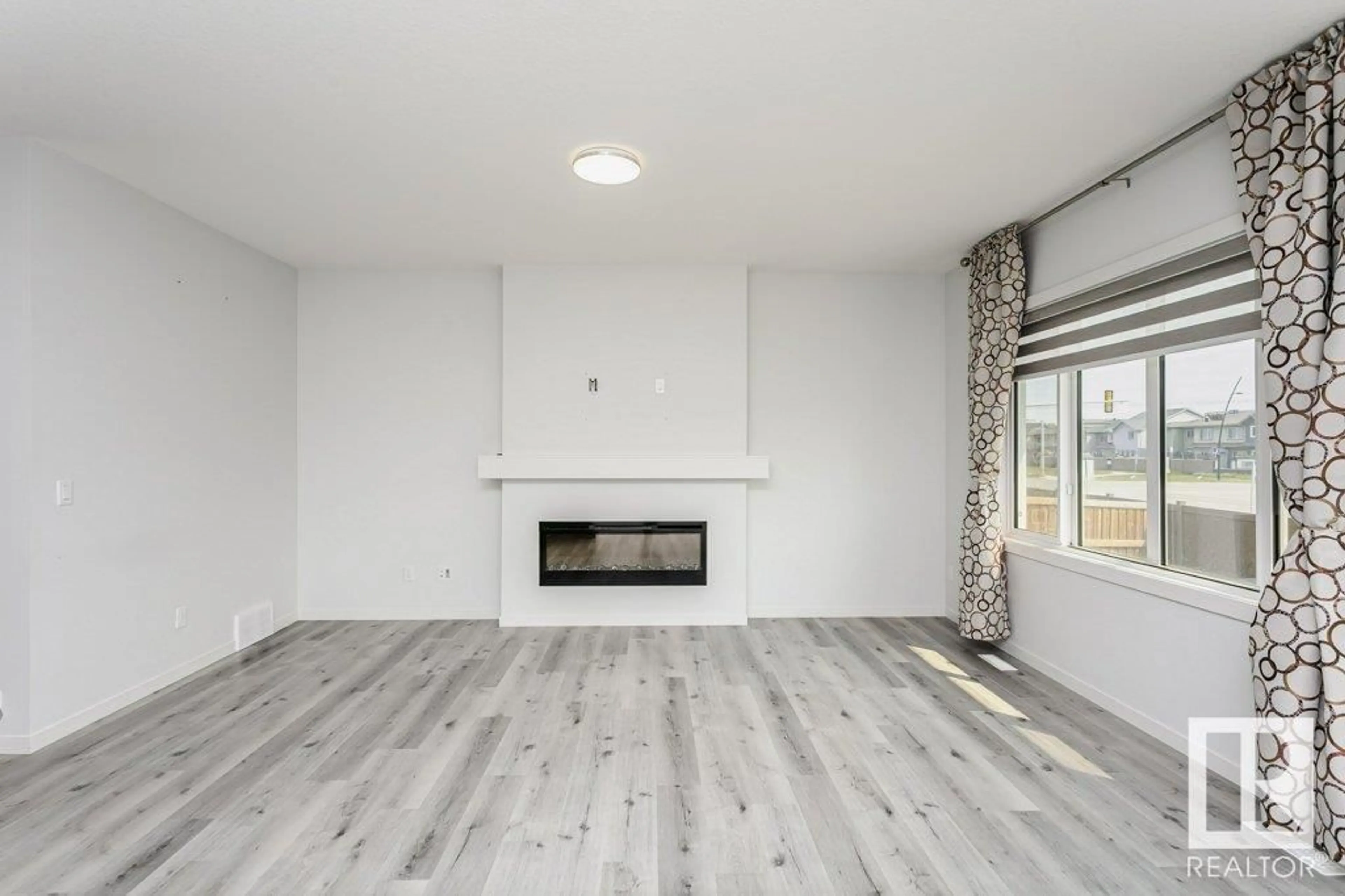 Living room with furniture, wood/laminate floor for NW - 2627 200 ST, Edmonton Alberta T6M1K3
