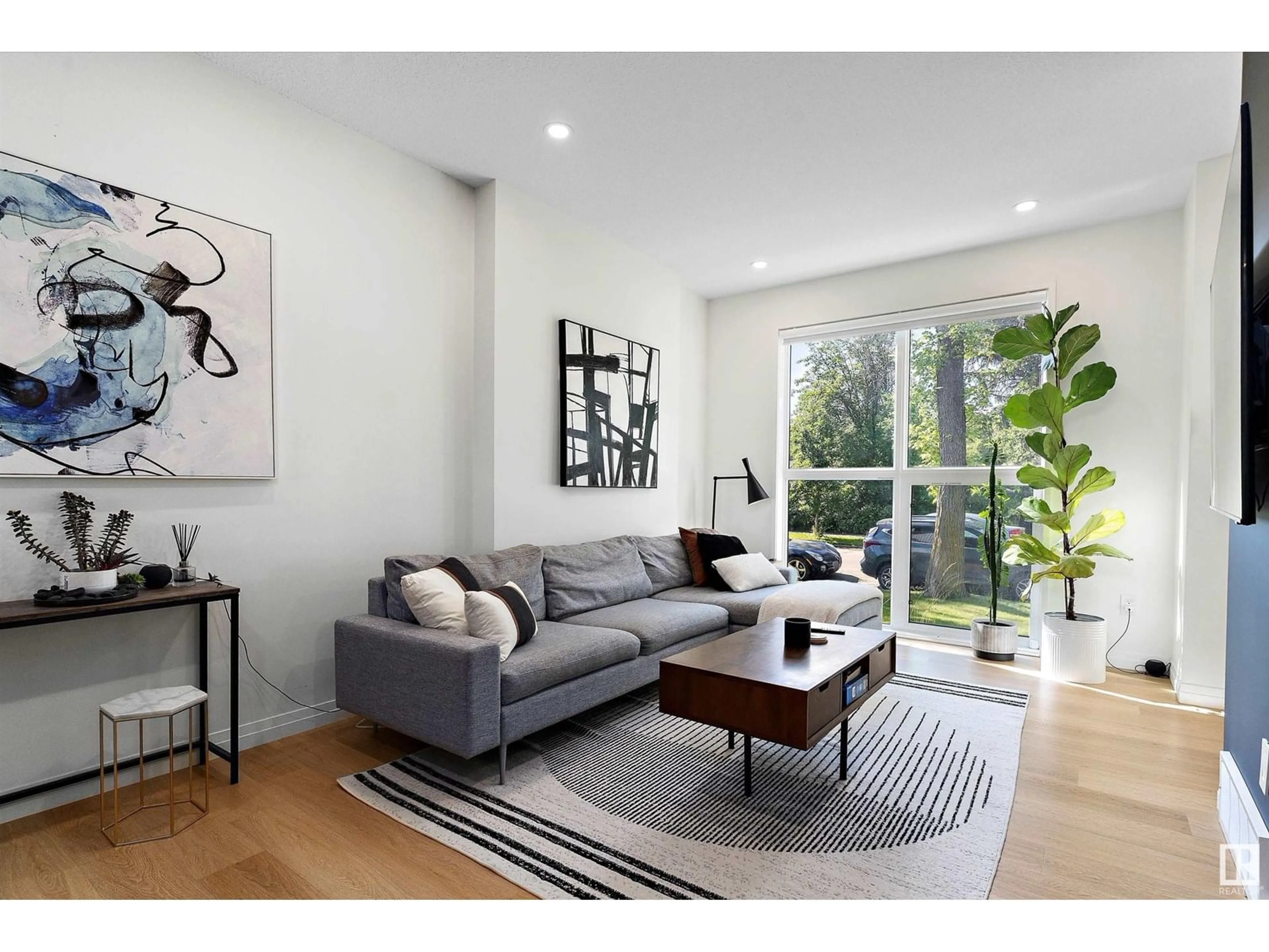 Living room with furniture, wood/laminate floor for 12214 121 AV, Edmonton Alberta T5L3C3