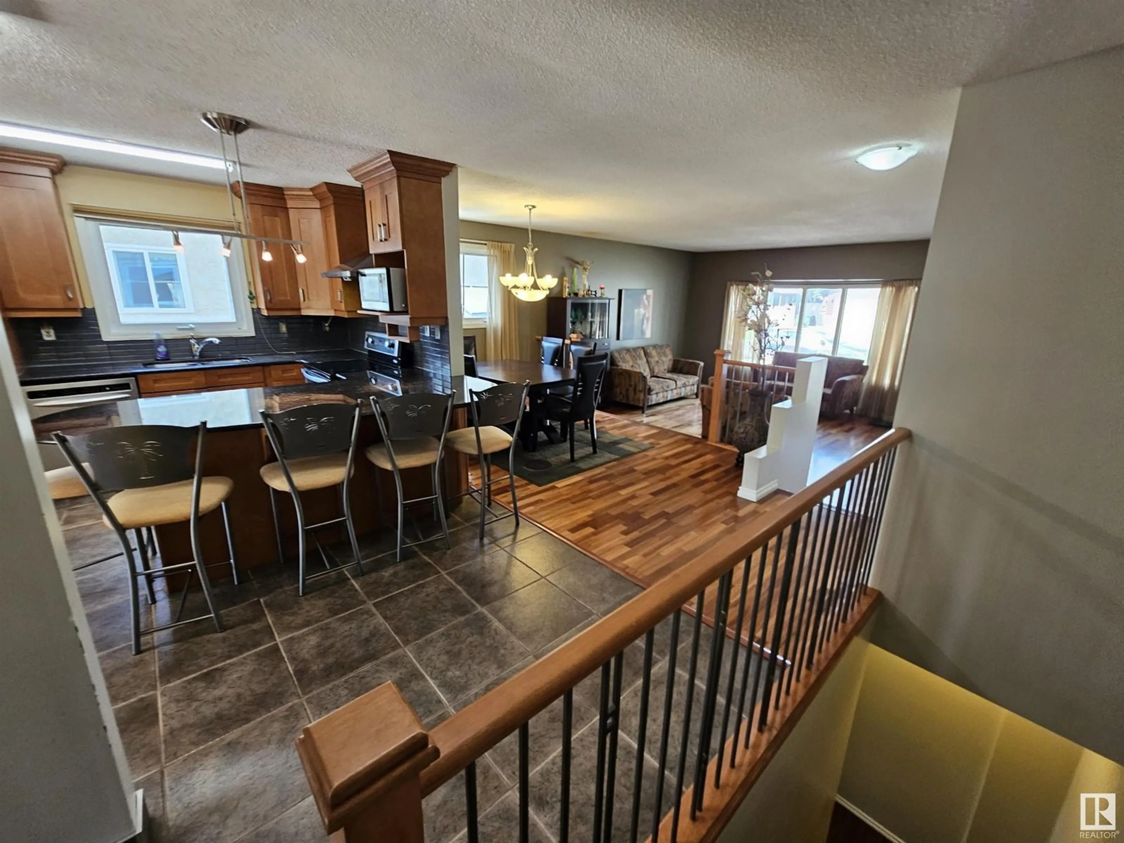 Open concept kitchen, wood/laminate floor for 14812 56 ST, Edmonton Alberta T5A4H6