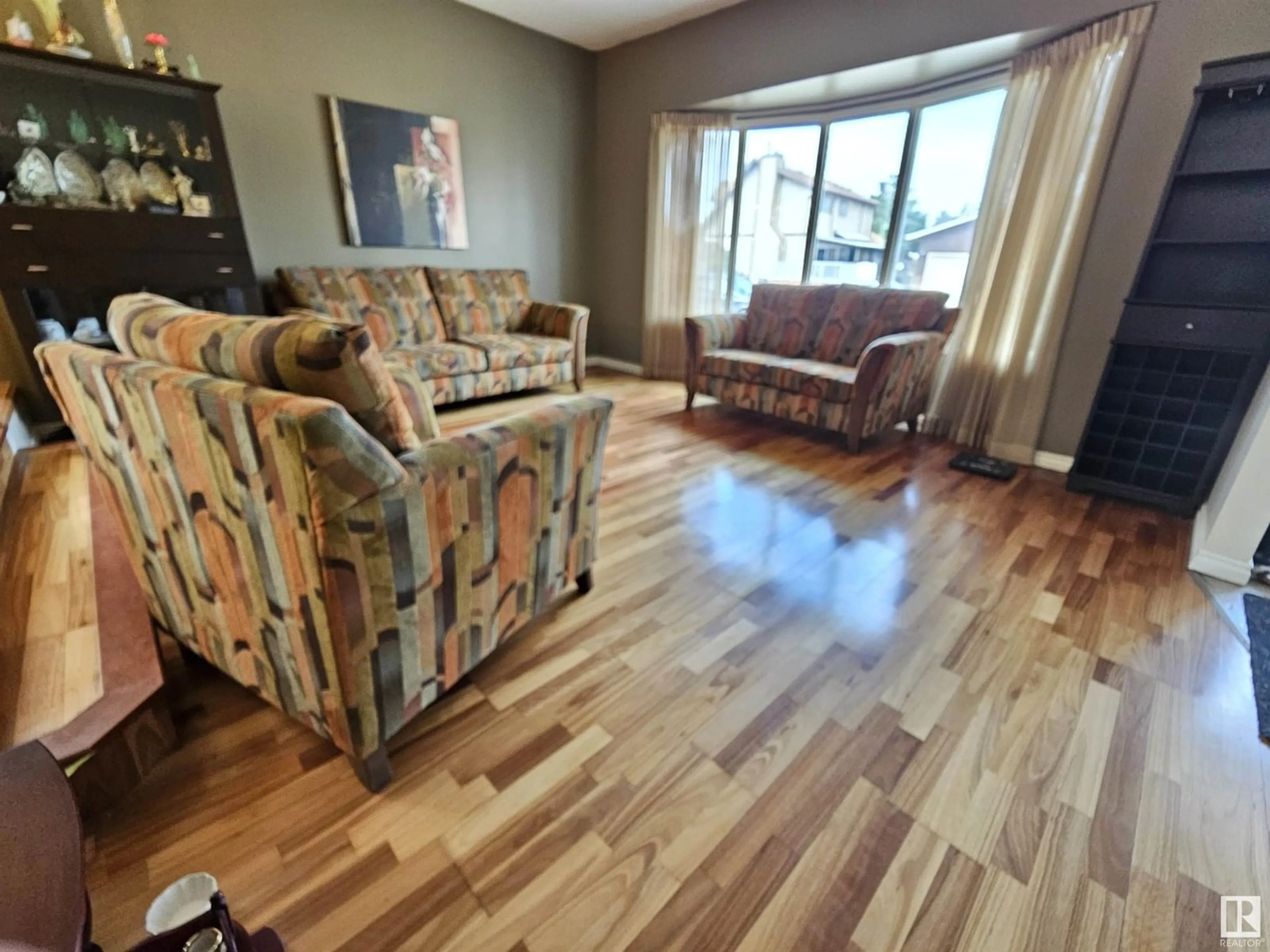 Living room with furniture, wood/laminate floor for 14812 56 ST, Edmonton Alberta T5A4H6