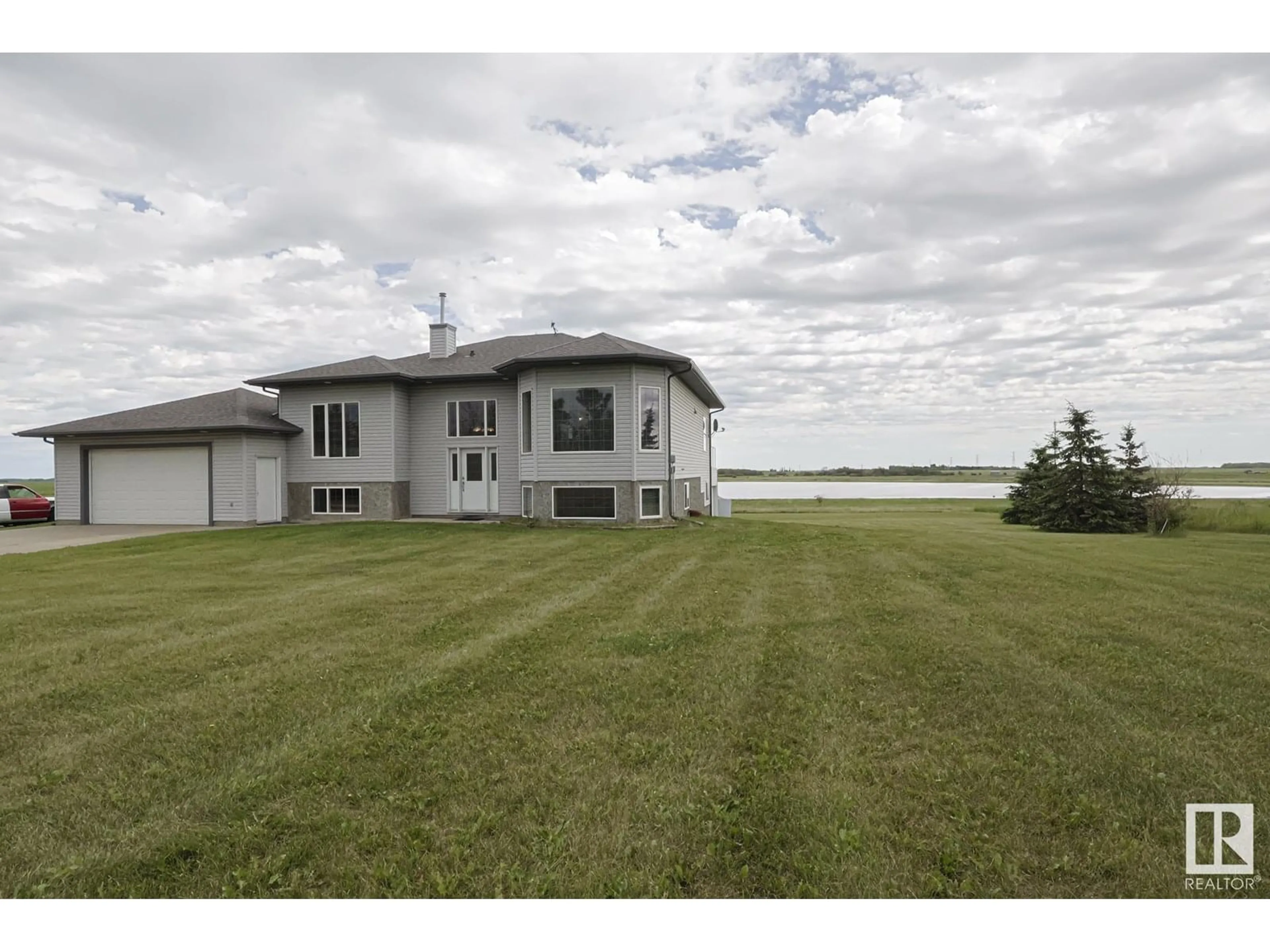 A pic from outside/outdoor area/front of a property/back of a property/a pic from drone, water/lake/river/ocean view for 55415 HWY 28 A, Rural Sturgeon County Alberta T0A1N1