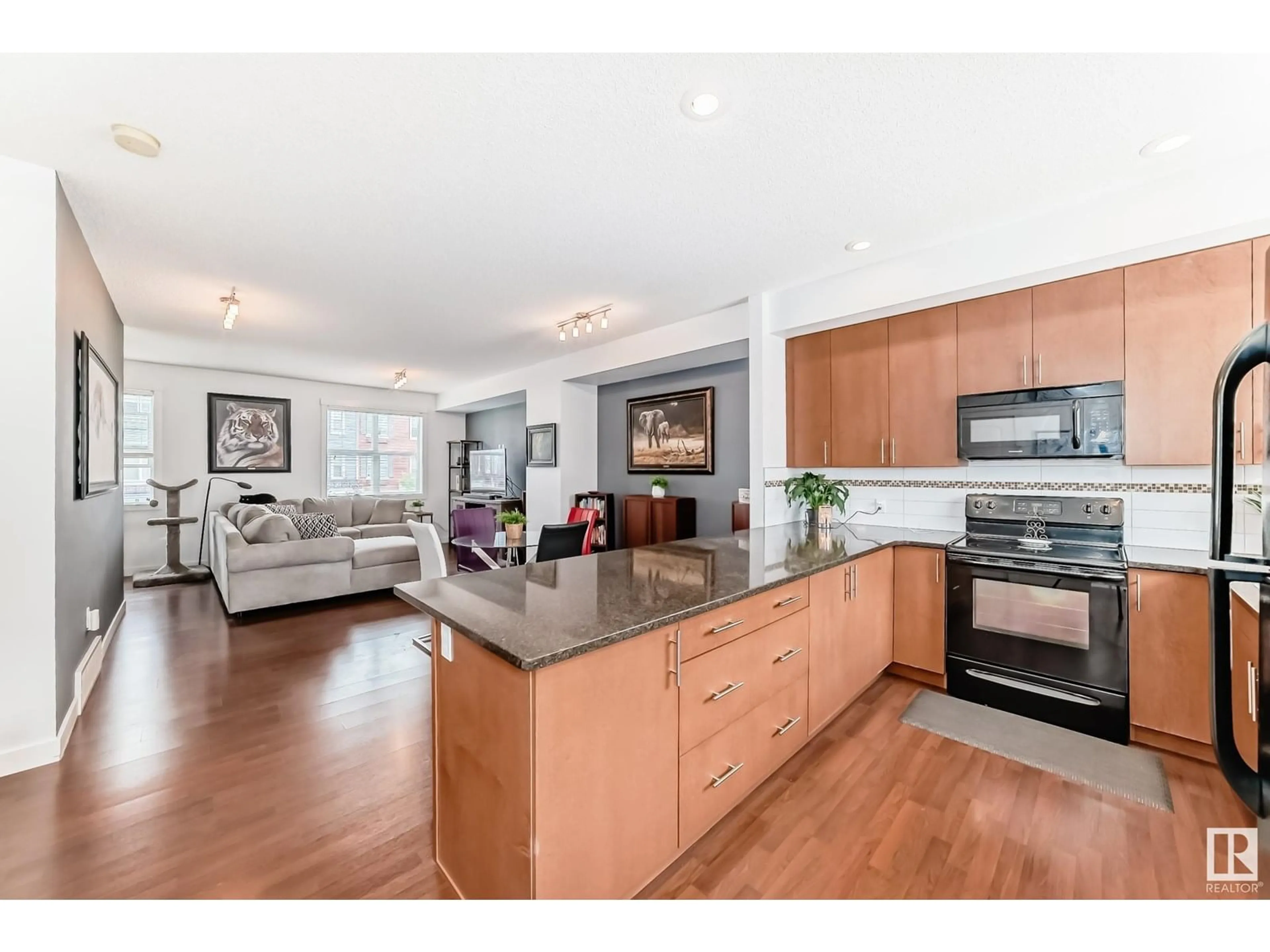 Open concept kitchen, wood/laminate floor for 92 8315 180 AV NW, Edmonton Alberta T5Z0J2