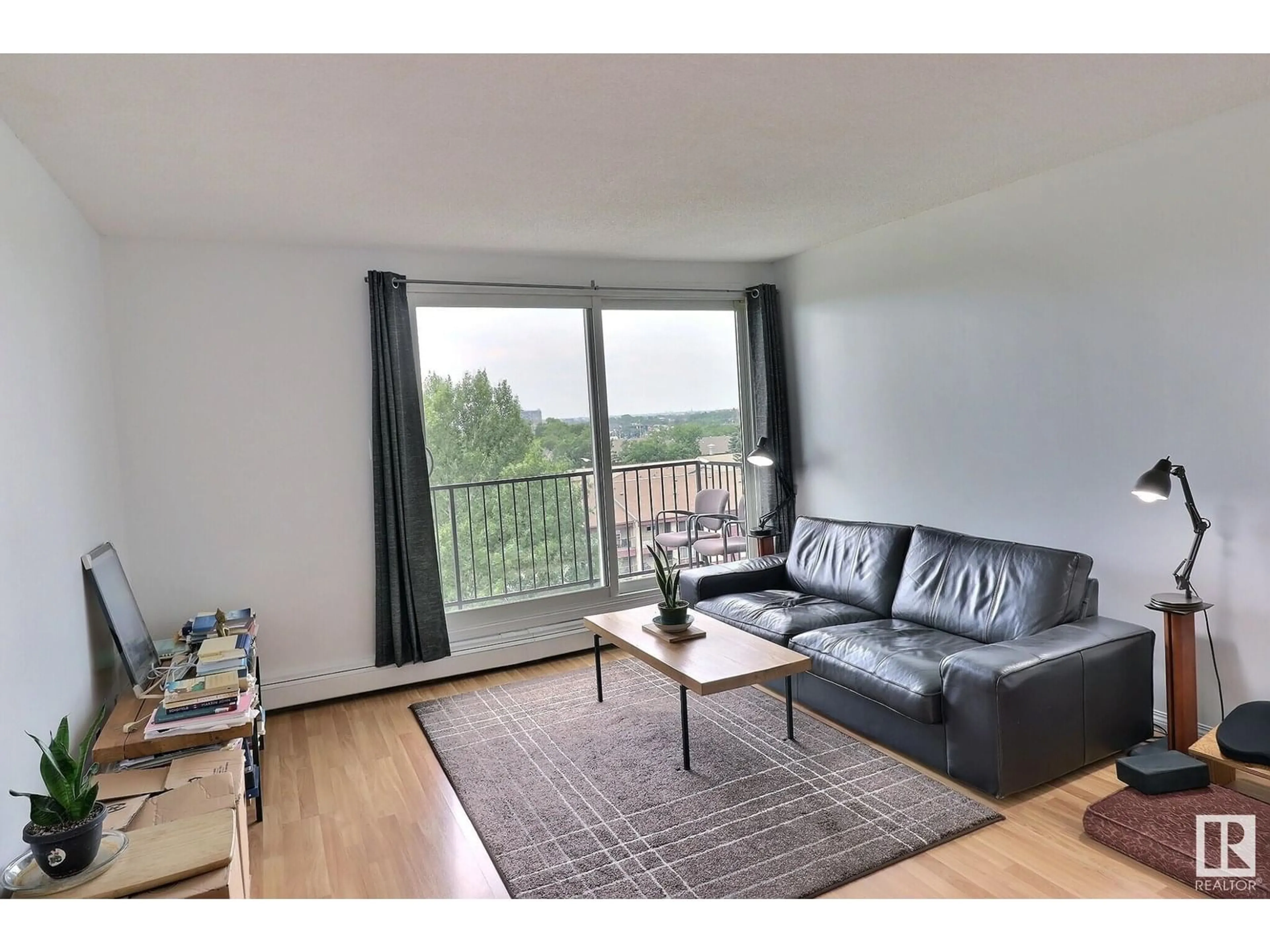 Living room with furniture, wood/laminate floor for 9028 NW - 805 JASPER AV, Edmonton Alberta T5H3Y6